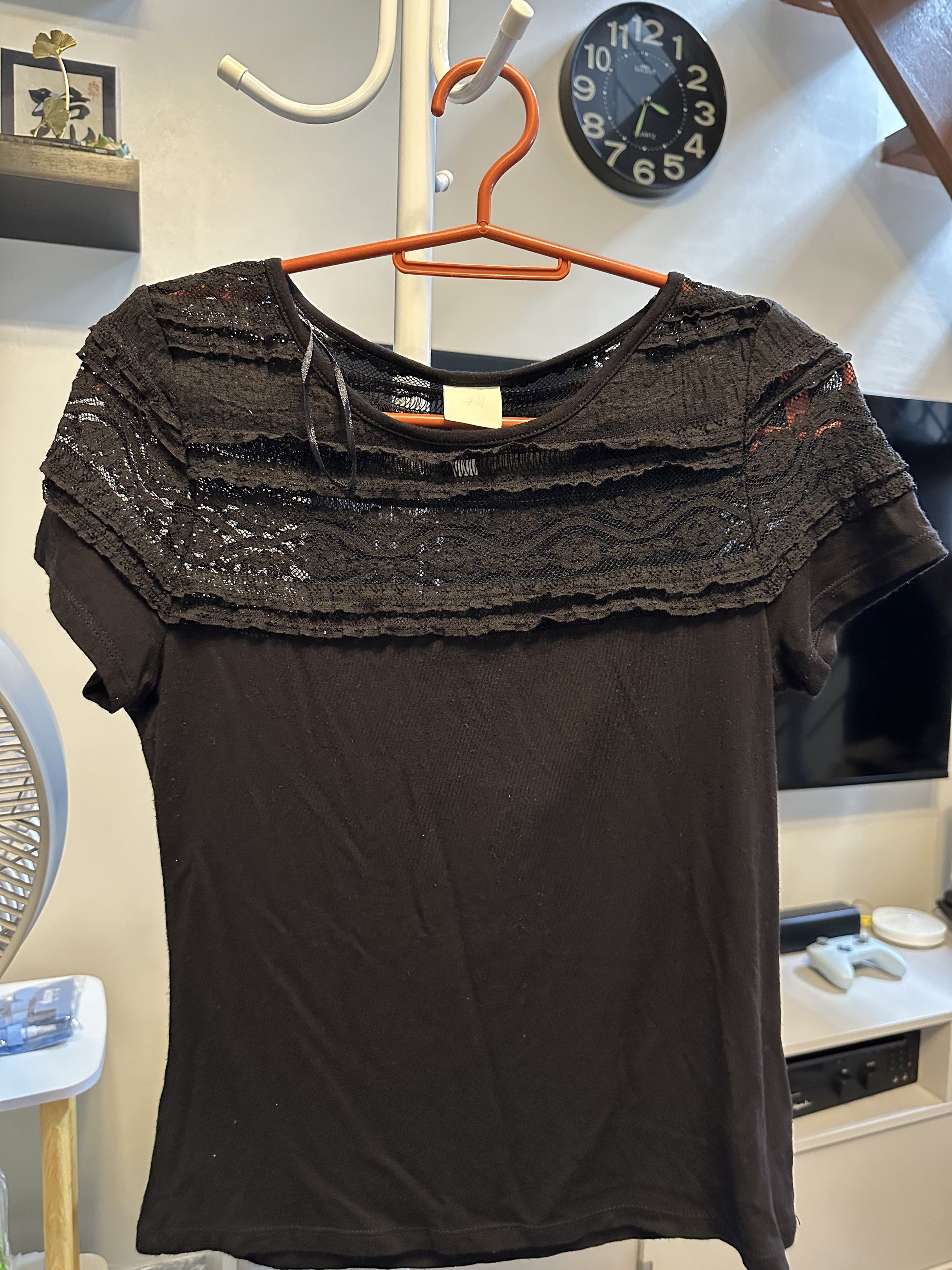 H&M Black Lace Top - Size S (Category: Blouses) located in Makati City. Submitted by ideclutteritems.ph (Listing ID 1418854808, Image 1). Description: - H&M black top - Size: S - Features lace detail on chest and shoulders - Short sleeves - Round neckline - Solid black fabric with lace overlay - Suitable for various occasions.