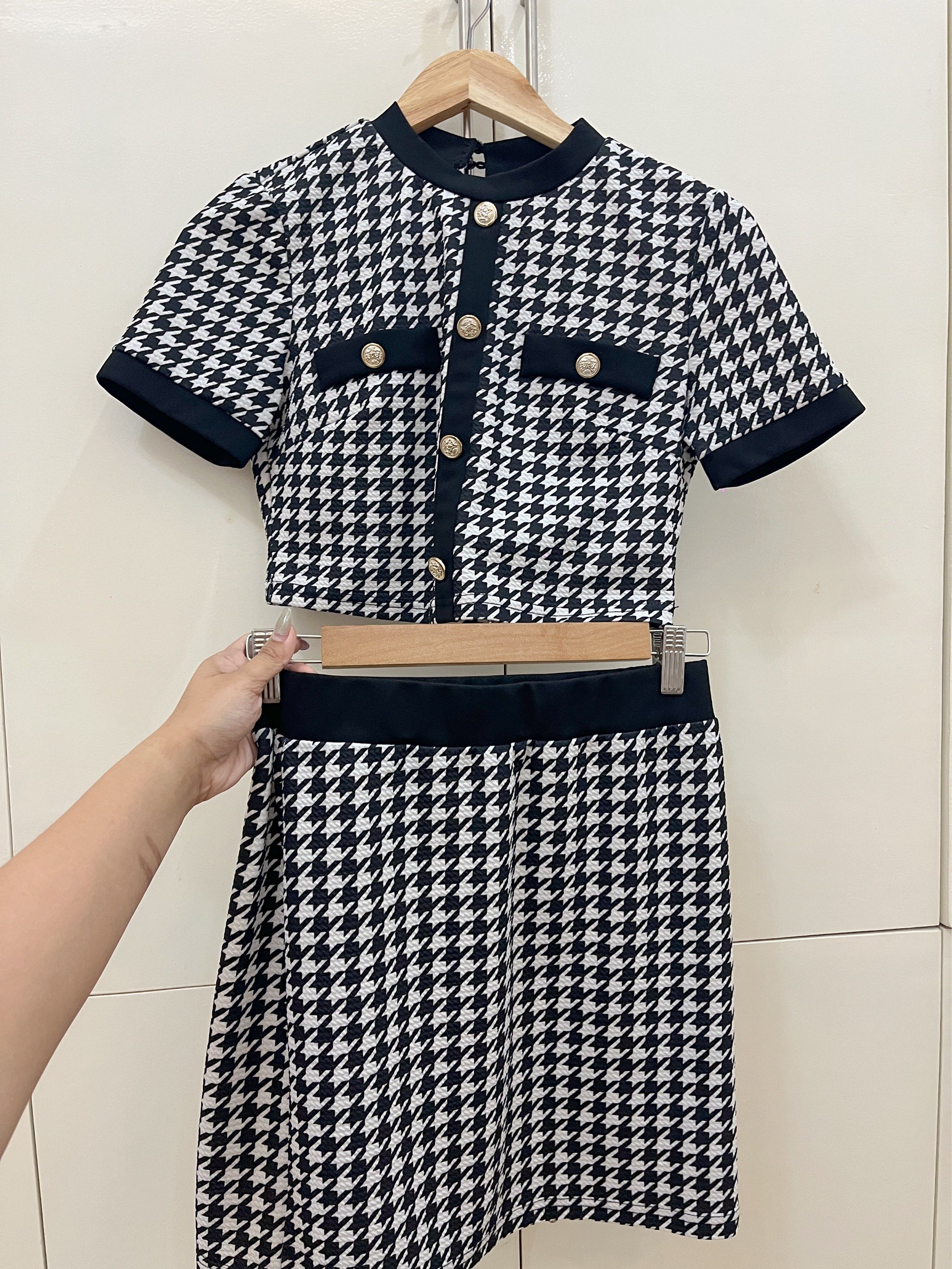 Houndstooth Crop Top and Skirt Set (Category: Sets or Coordinates) located in Quezon City. Submitted by cheeseburgerry (Listing ID 1418902094, Image 1). Description: - Houndstooth skirt set - Crop top features: - Short sleeves - Round neckline - Gold buttons - Mini skirt with black waistband - Perfect for a chic look.