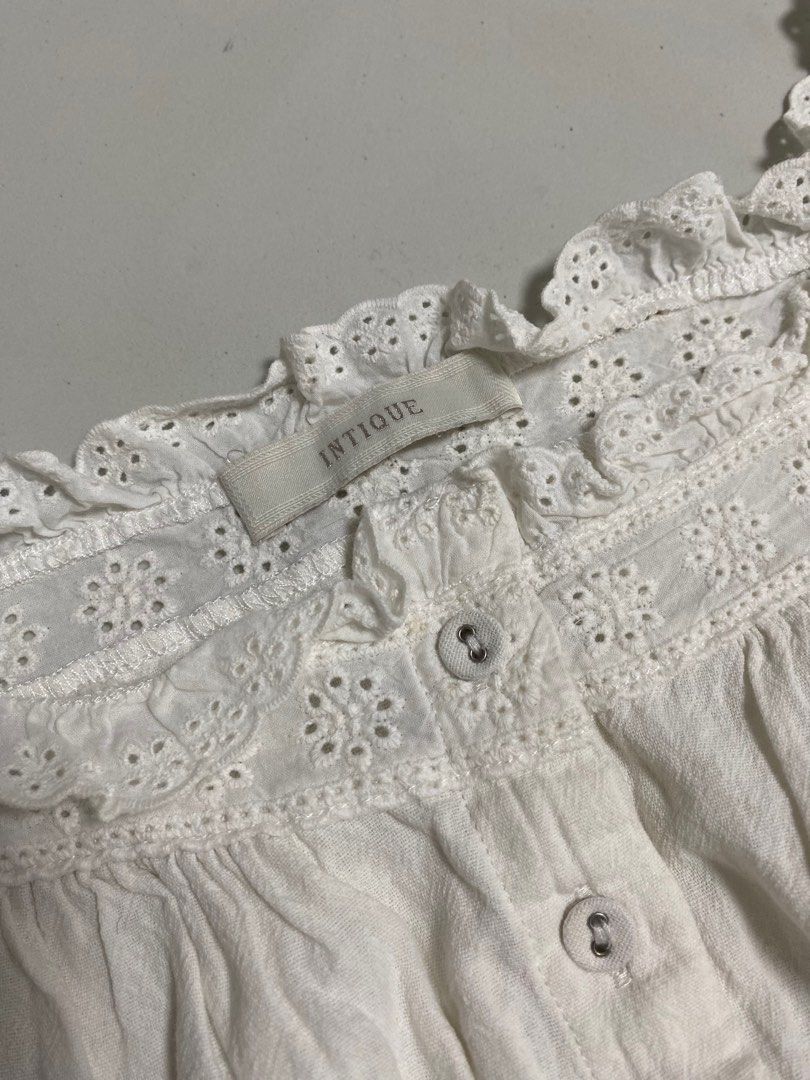 Intique Vintage White Eyelet Top (Category: Blouses) located in Calamba. Submitted by curse.thin_ (Listing ID 1418778487, Image 2). Description: - Intique white eyelet top - Button-down front - Delicate eyelet detailing - Cropped length - Ruffled trim - Lightweight fabric - Perfect for warm weather - Dress up or down.