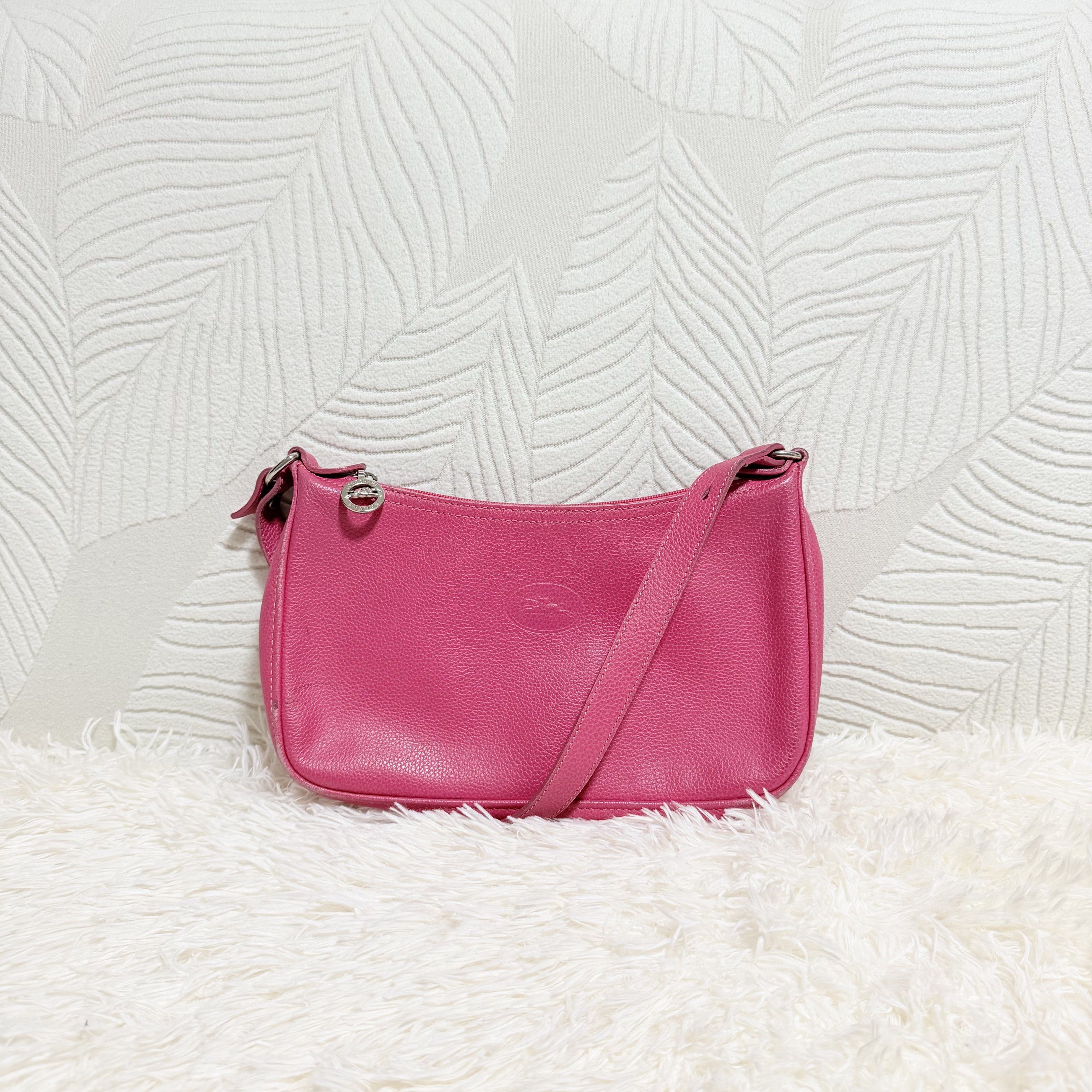 Longchamp Le Pliage Cuir Shoulder Bag (Category: Luxury Bags & Wallets) located in Pasig City. Submitted by trendapparelph (Listing ID 1418849646, Image 1). Description: - Authentic Longchamp Le Pliage Cuir shoulder bag - Vibrant pink color - Made of genuine leather - Features a zip closure - Includes a shoulder strap - Interior pocket - Made in France - Iconic Longchamp logo details.