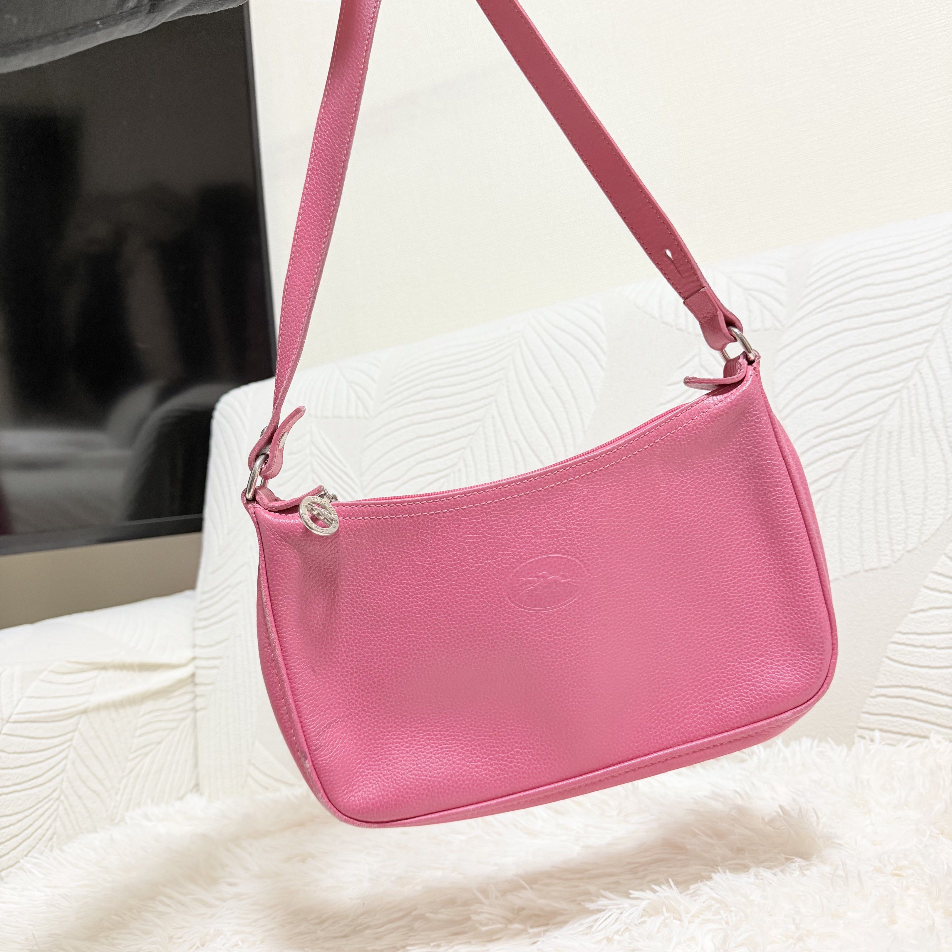 Longchamp Le Pliage Cuir Shoulder Bag (Category: Luxury Bags & Wallets) located in Pasig City. Submitted by trendapparelph (Listing ID 1418849646, Image 3). Description: - Authentic Longchamp Le Pliage Cuir shoulder bag - Vibrant pink color - Made of genuine leather - Features a zip closure - Includes a shoulder strap - Interior pocket - Made in France - Iconic Longchamp logo details.