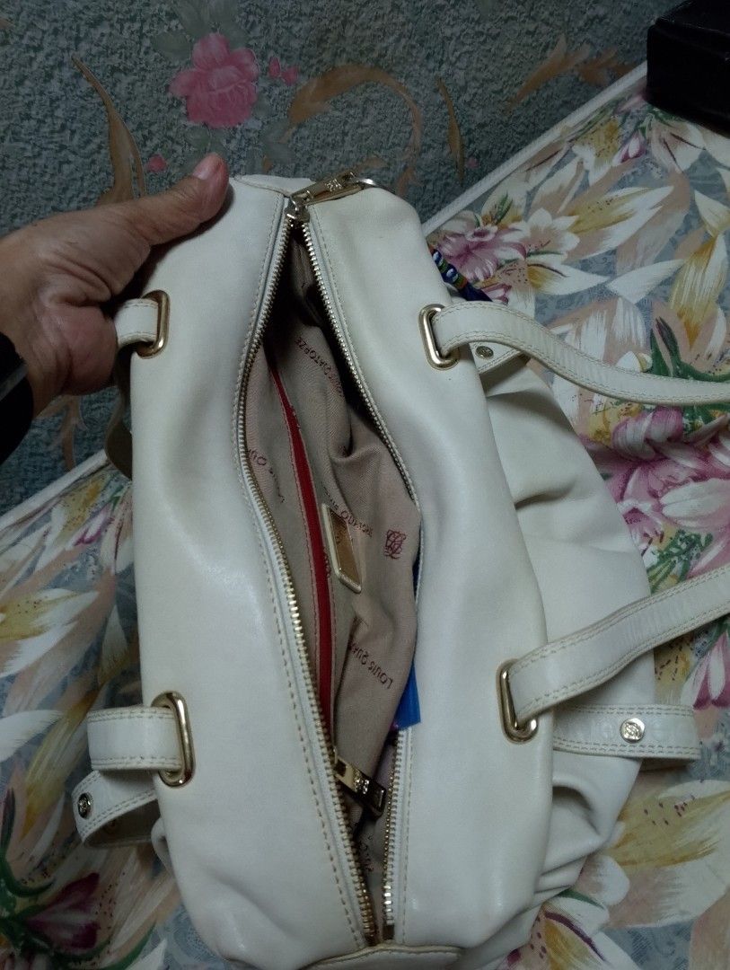 Louis Quatorze White Shoulder Bag (Category: Shoulder Bags) located in Caloocan City. Submitted by nobleflower_4c42cc (Listing ID 1418973223, Image 3). Description: - Louis Quatorze white shoulder bag - Zip closure - Two shoulder straps - Gold-colored hardware - Red interior lining with Louis Quatorze label - Decorative studs.