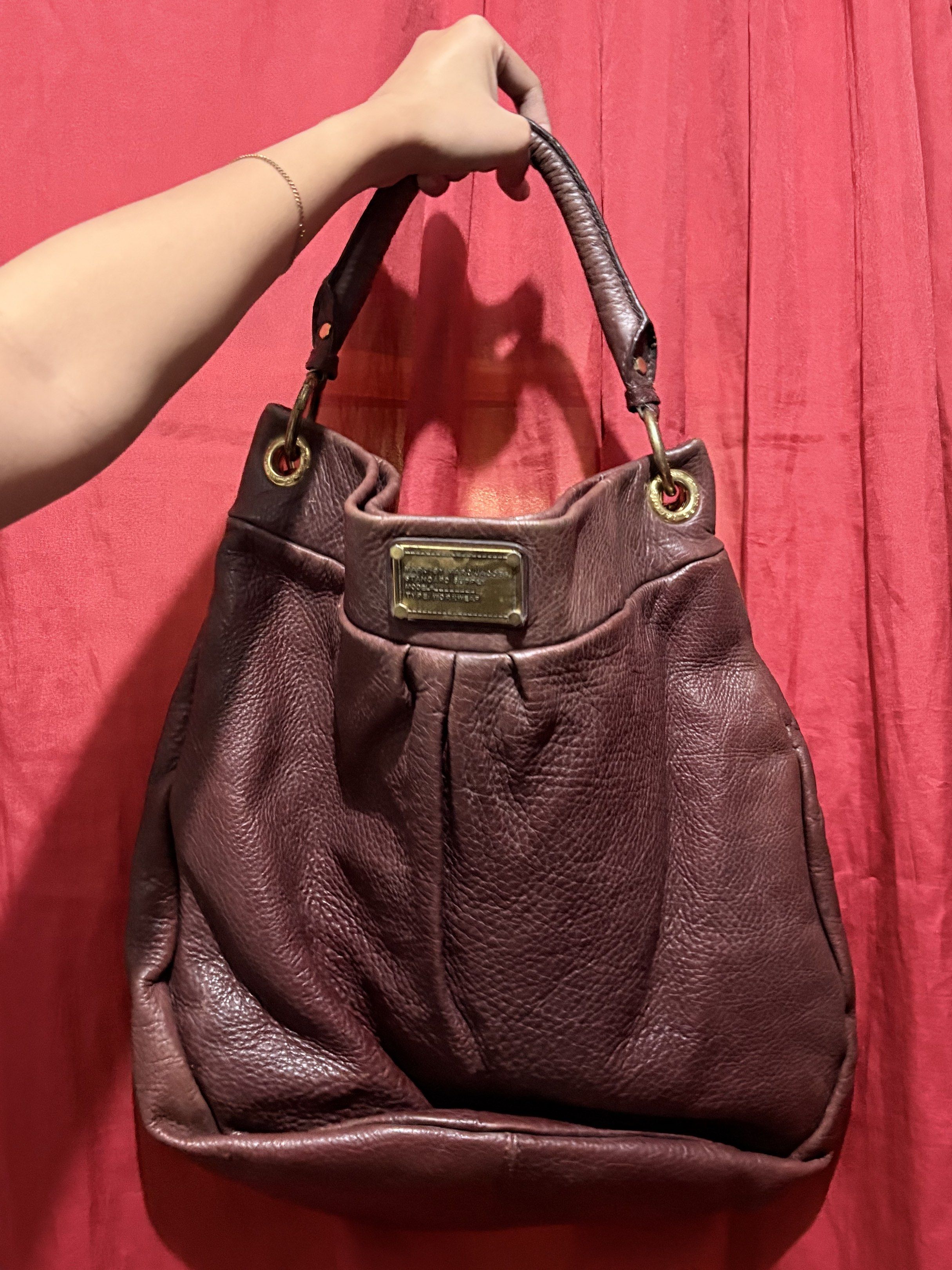 Marc Jacobs Leather Hobo Bag (Category: Luxury Bags & Wallets) located in Manila. Submitted by cufflej (Listing ID 1418958042, Image 1). Description: - Authentic Marc Jacobs hobo bag - Rich burgundy color - Made of high-quality leather - Top handle and detachable shoulder strap - Interior lined with Marc Jacobs logo - Includes small metal brand plate.