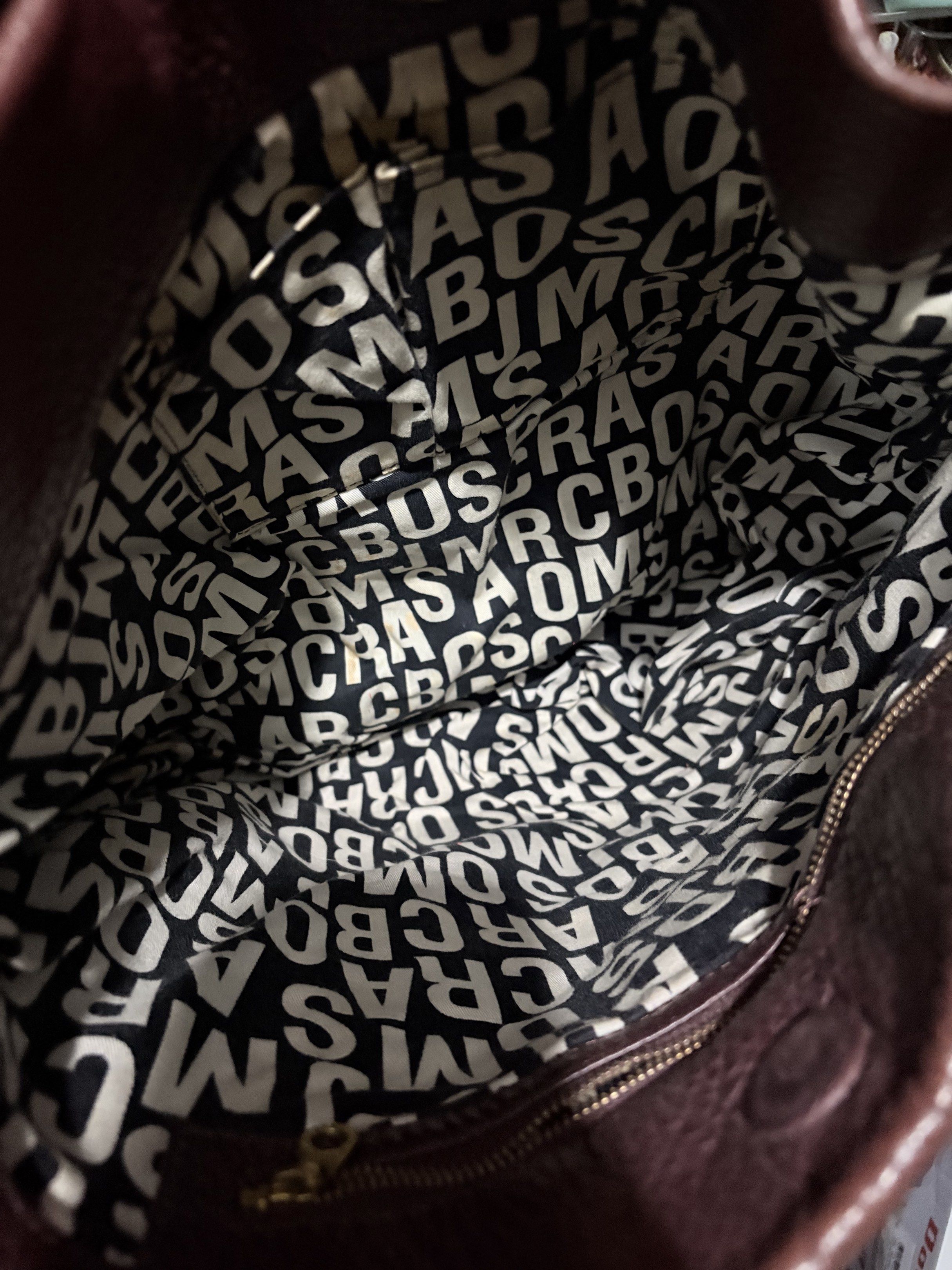Marc Jacobs Leather Hobo Bag (Category: Luxury Bags & Wallets) located in Manila. Submitted by cufflej (Listing ID 1418958042, Image 3). Description: - Authentic Marc Jacobs hobo bag - Rich burgundy color - Made of high-quality leather - Top handle and detachable shoulder strap - Interior lined with Marc Jacobs logo - Includes small metal brand plate.