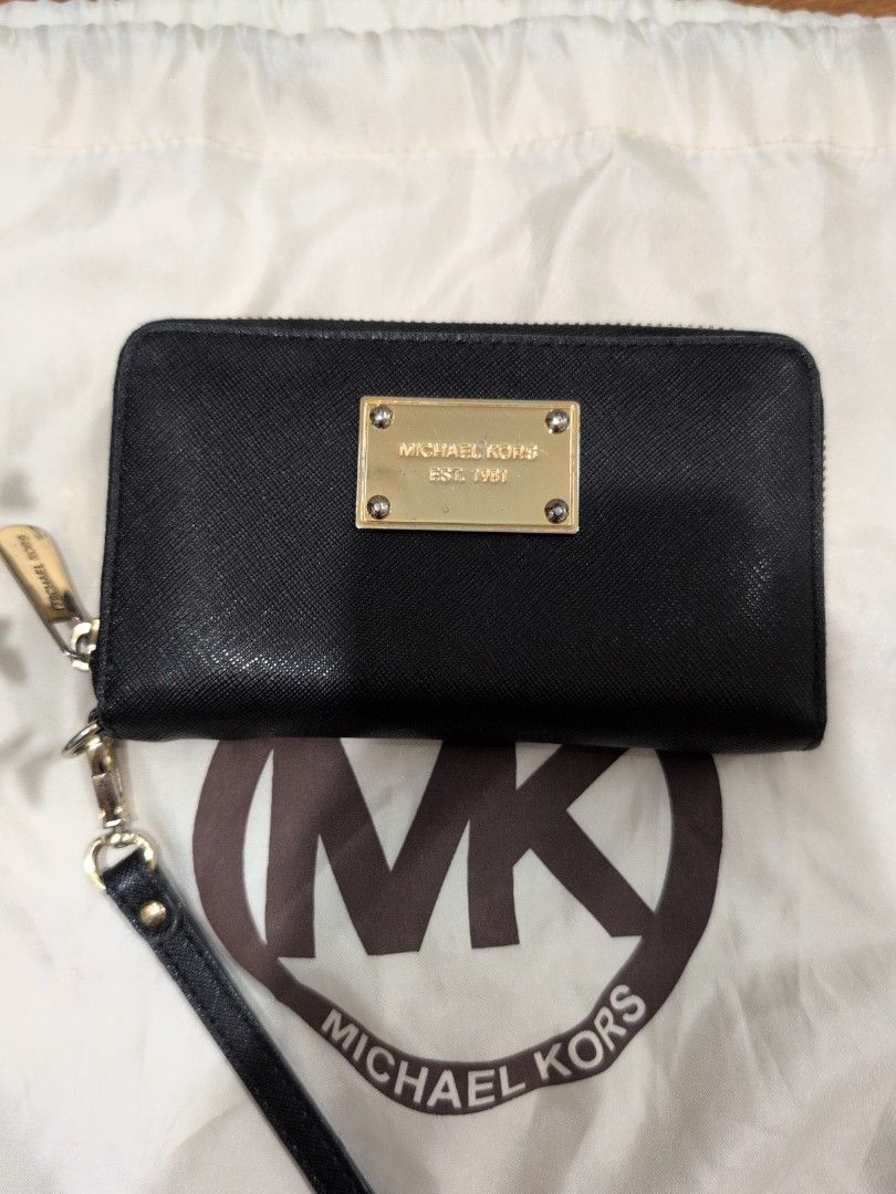 Michael Kors Black Zip Around Wallet (Category: Wallets & Card holders) located in Manila. Submitted by csisters3 (Listing ID 1418890269, Image 1). Description: - Michael Kors black zip-around wallet - Gold-tone metal plate with "Michael Kors 1981" - Multiple card slots and compartments - Includes a wrist strap - Gold-toned zipper and hardware bought in 2013 leather still in good condition .