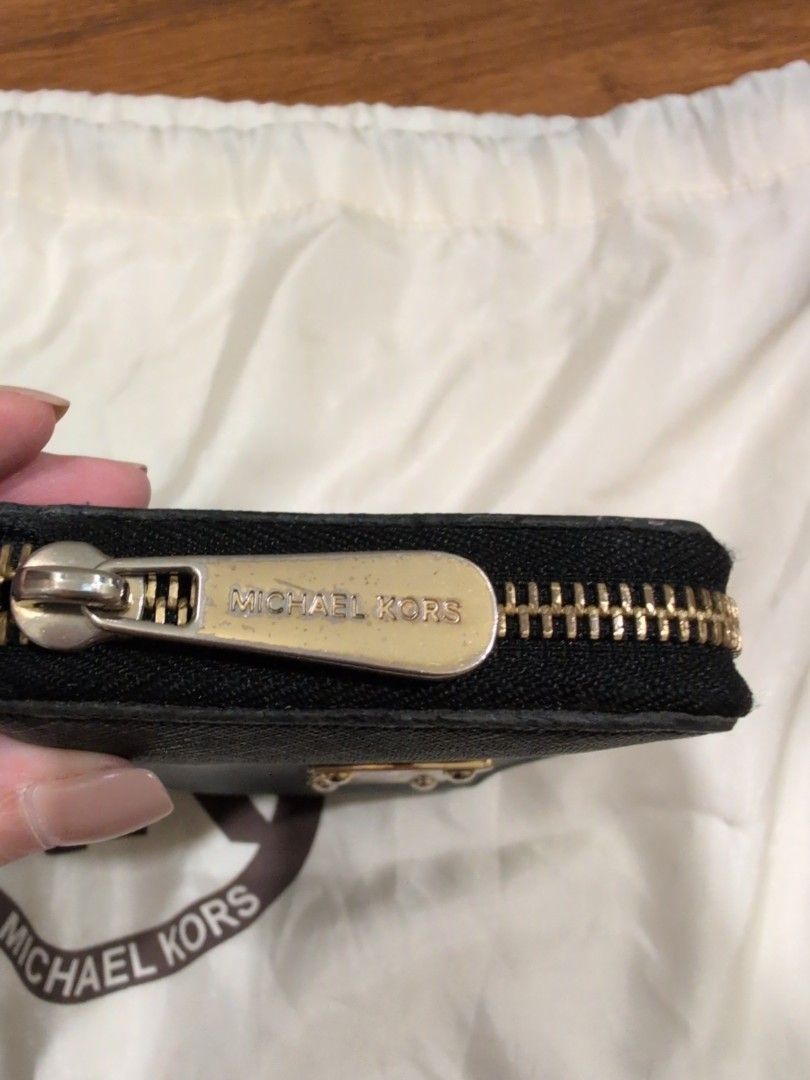 Michael Kors Black Zip Around Wallet (Category: Wallets & Card holders) located in Manila. Submitted by csisters3 (Listing ID 1418890269, Image 3). Description: - Michael Kors black zip-around wallet - Gold-tone metal plate with "Michael Kors 1981" - Multiple card slots and compartments - Includes a wrist strap - Gold-toned zipper and hardware bought in 2013 leather still in good condition .
