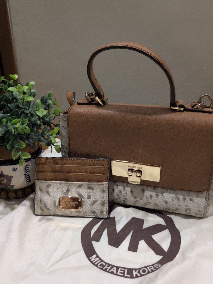Michael Kors Handbag with Card Holder (Category: Luxury Bags & Wallets) located in Manila. Submitted by csisters3 (Listing ID 1418891121, Image 1). Description: - Authentic Michael Kors handbag - Tan and white monogram design - Includes matching card holder - Features top handle and long strap (removable) - Multiple interior compartments - Includes zippered pocket - Includes care card -bought in 2018 in the US.