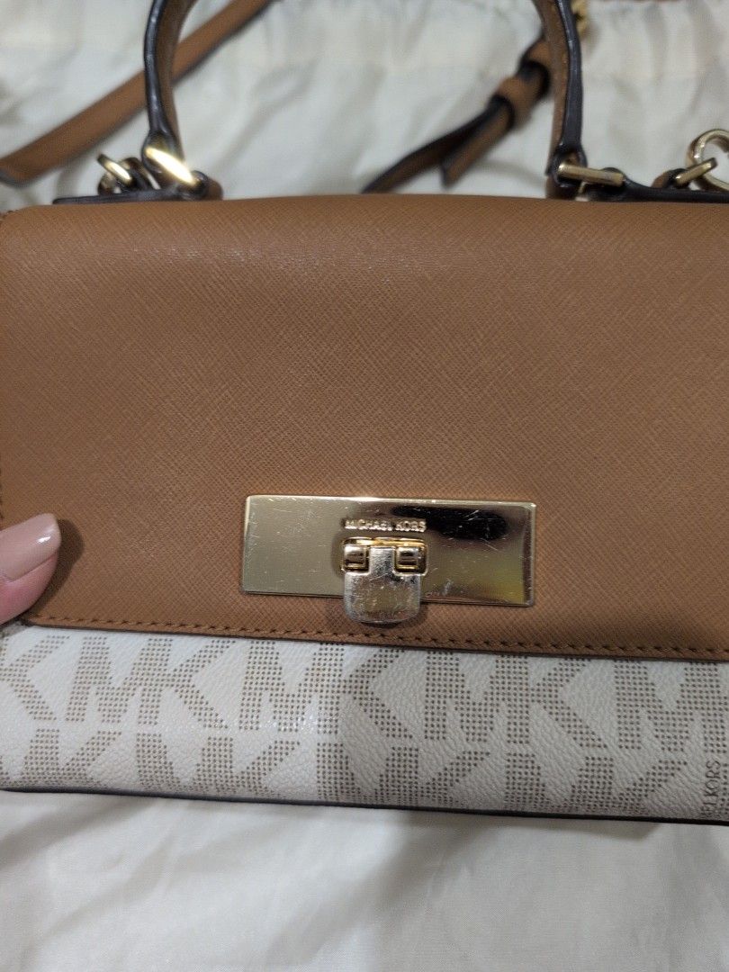 Michael Kors Handbag with Card Holder (Category: Luxury Bags & Wallets) located in Manila. Submitted by csisters3 (Listing ID 1418891121, Image 2). Description: - Authentic Michael Kors handbag - Tan and white monogram design - Includes matching card holder - Features top handle and long strap (removable) - Multiple interior compartments - Includes zippered pocket - Includes care card -bought in 2018 in the US.