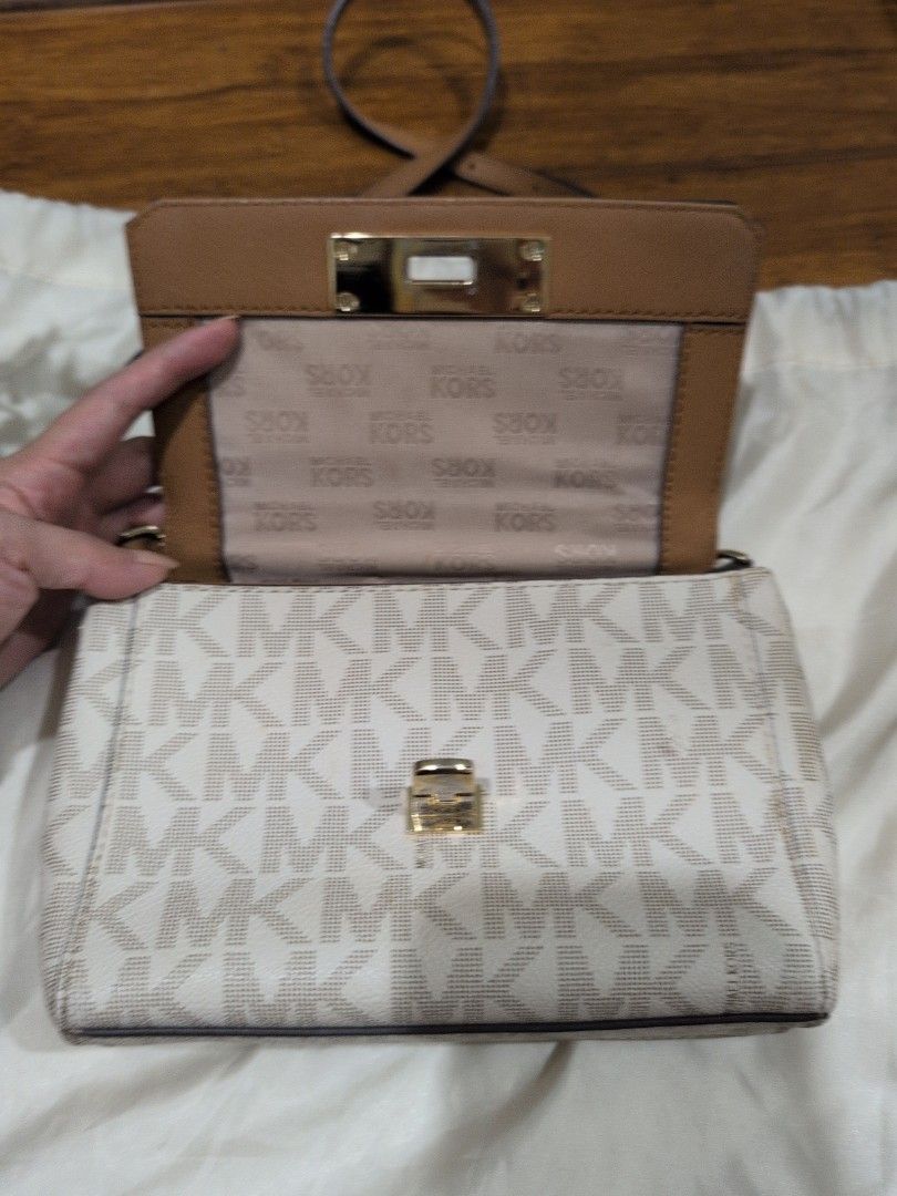 Michael Kors Handbag with Card Holder (Category: Luxury Bags & Wallets) located in Manila. Submitted by csisters3 (Listing ID 1418891121, Image 3). Description: - Authentic Michael Kors handbag - Tan and white monogram design - Includes matching card holder - Features top handle and long strap (removable) - Multiple interior compartments - Includes zippered pocket - Includes care card -bought in 2018 in the US.