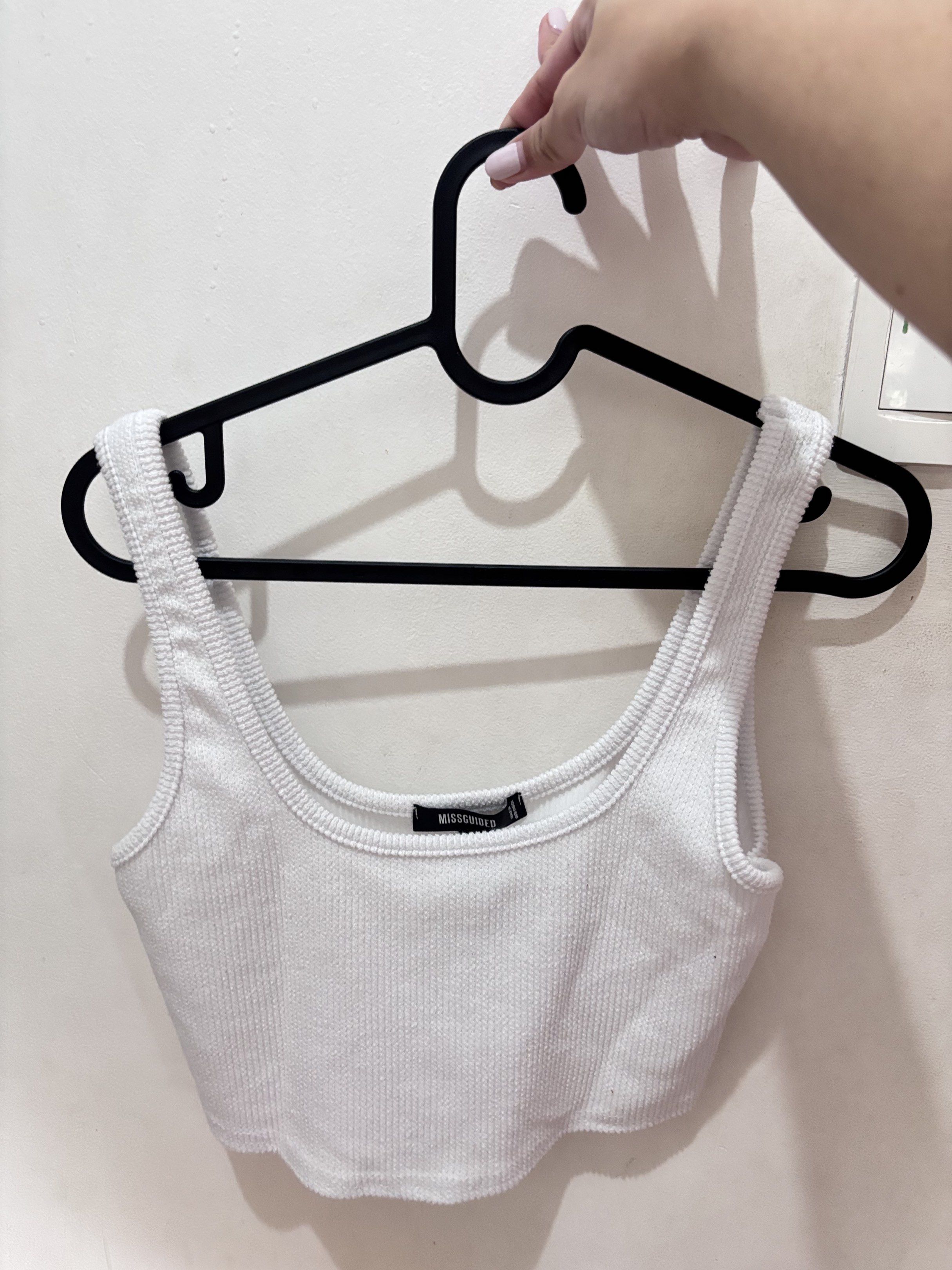 Missguided White Ribbed Crop Top (Category: Sleeveless) located in Meycauayan. Submitted by declutter0403 (Listing ID 1418846380, Image 1). Description: - Missguided white ribbed crop top - Scoop neckline - Fitted silhouette - UK size 10 (fits EUR 38, US 6) - Made in the United Kingdom.
