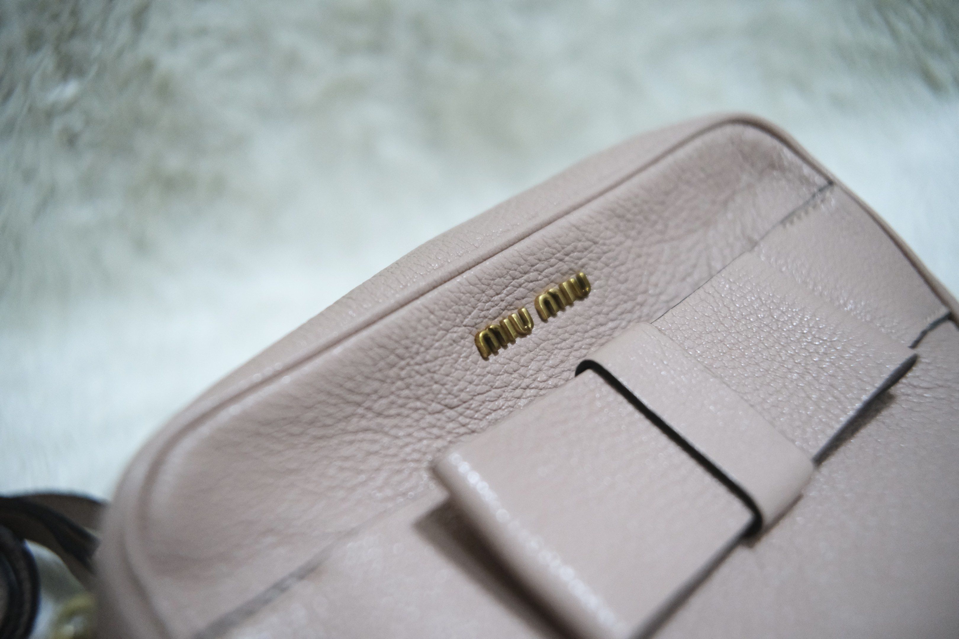 Miu Miu Bow Crossbody Bag (Category: Luxury Bags & Wallets) located in Cebu City. Submitted by heysummerph (Listing ID 1418778175, Image 2). Description: - Authentic Miu Miu Crossbody Bag - Color: Neutral Pink - Material: Textured Leather - Features: - Bow detail - Zip closure - Detachable shoulder strap - Hardware: Gold-toned - Includes authenticity cards.