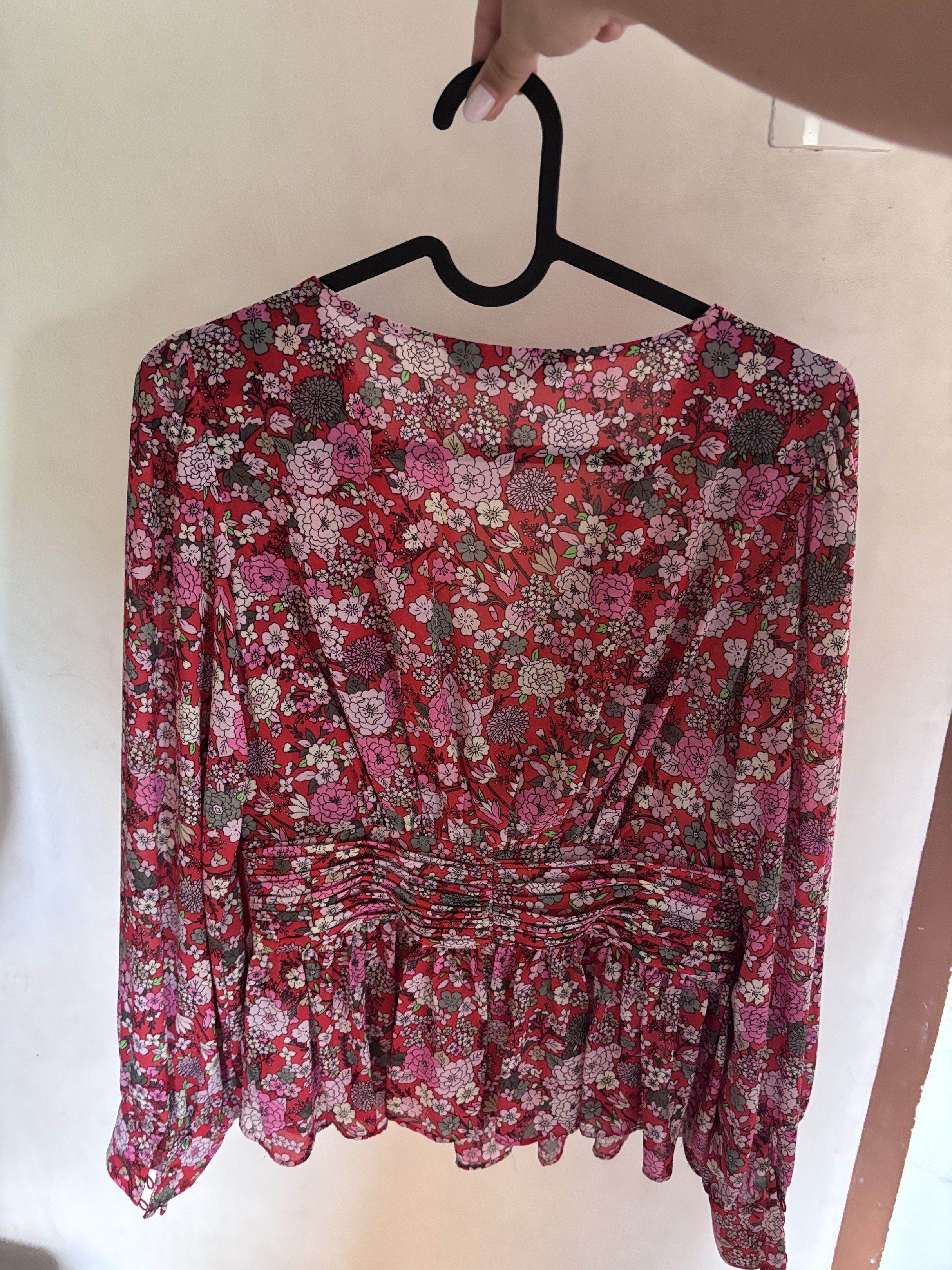 M&S Floral Blouse (Category: Blouses) located in Meycauayan. Submitted by declutter0403 (Listing ID 1418816634, Image 2). Description: - M&S floral blouse - Features a vibrant print in red, pink, and white - Design: V-neckline and long sleeves - Details: Gathered waist and peplum hem - Made in Myanmar.