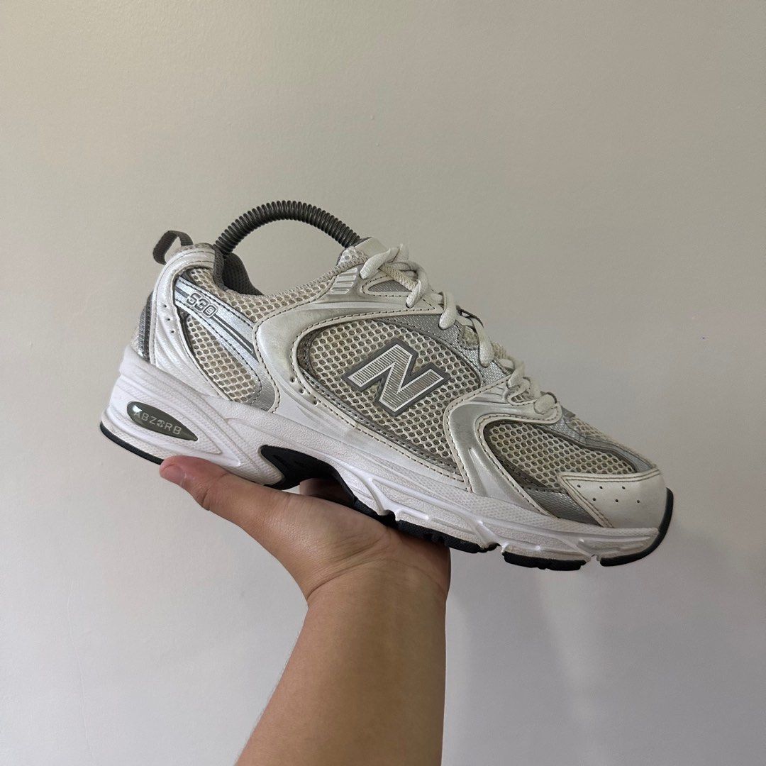 New Balance White Silver Metallic (Category: Sneakers) located in Davao. Submitted by culthriftph (Listing ID 1418866666, Image 1). Description: worn condition size 8US / 25 cm wmns yellow stains (washable) signs of usage.