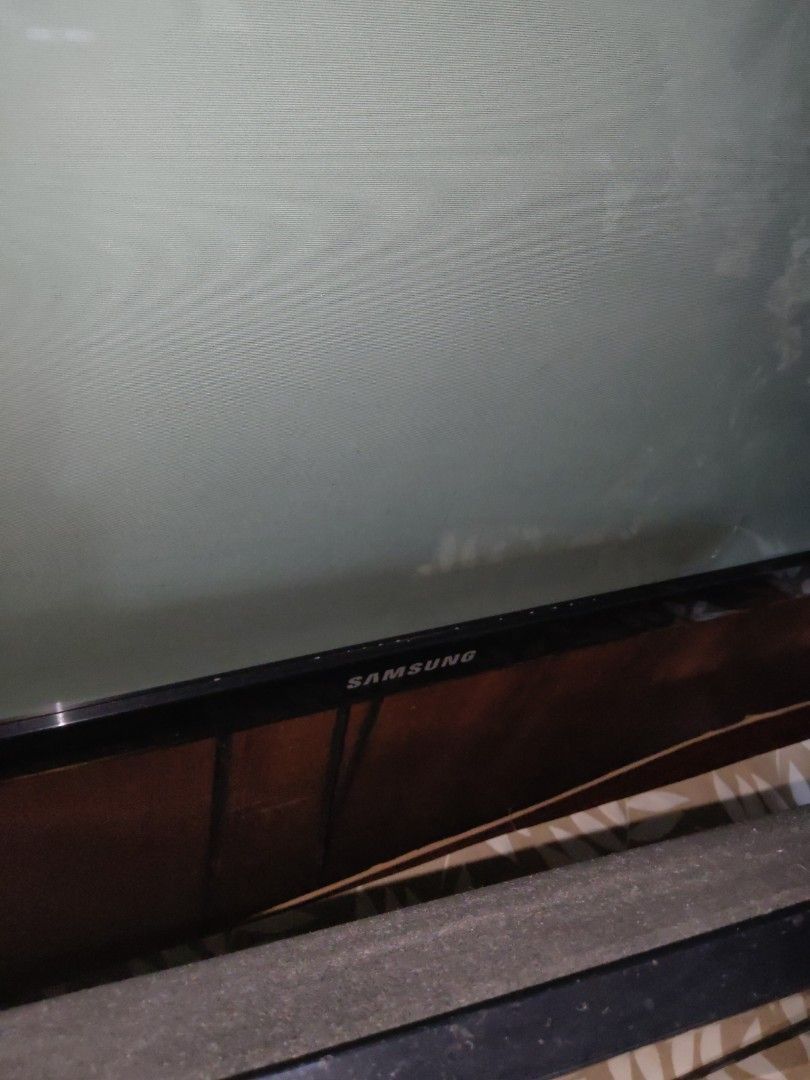 47" Not working Samsung smart TV (Category: TV) located in Quezon City. Submitted by purpleparrot (Listing ID 1418809796, Image 2). Description: - Parts can be sold -Samsung TV - Black frame - Clear screen - Multiple angles shown in photos - Placed on a wooden surface.