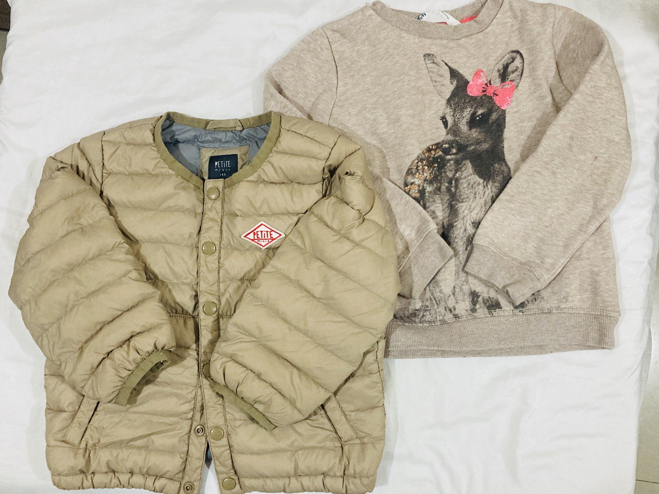 Petite Jacket and H&M Sweatshirt bundle (Category: Babies & Kids Fashion) located in La Trinidad. Submitted by secondsmatter (Listing ID 1418902586, Image 1). Description: - Petite light brown quilted jacket (excellent condition) - H&M beige sweatshirt with deer graphic and round neck (with signs of usage) - Both items are for children..