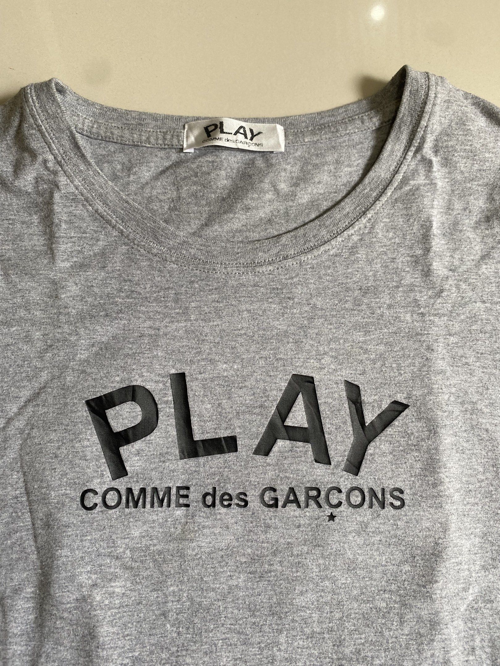 Play Comme des Garcons Grey T-shirt (Category: Tshirts & Polo Shirts ) located in Quezon City. Submitted by cointhrift (Listing ID 1418801642, Image 3). Description: - Grey Play Comme des Garcons T-shirt - Features brand logo on front - Iconic heart with eyes on back - Made in Japan - 100% Cotton - Crew neck - Short sleeves -19x26 dimension.