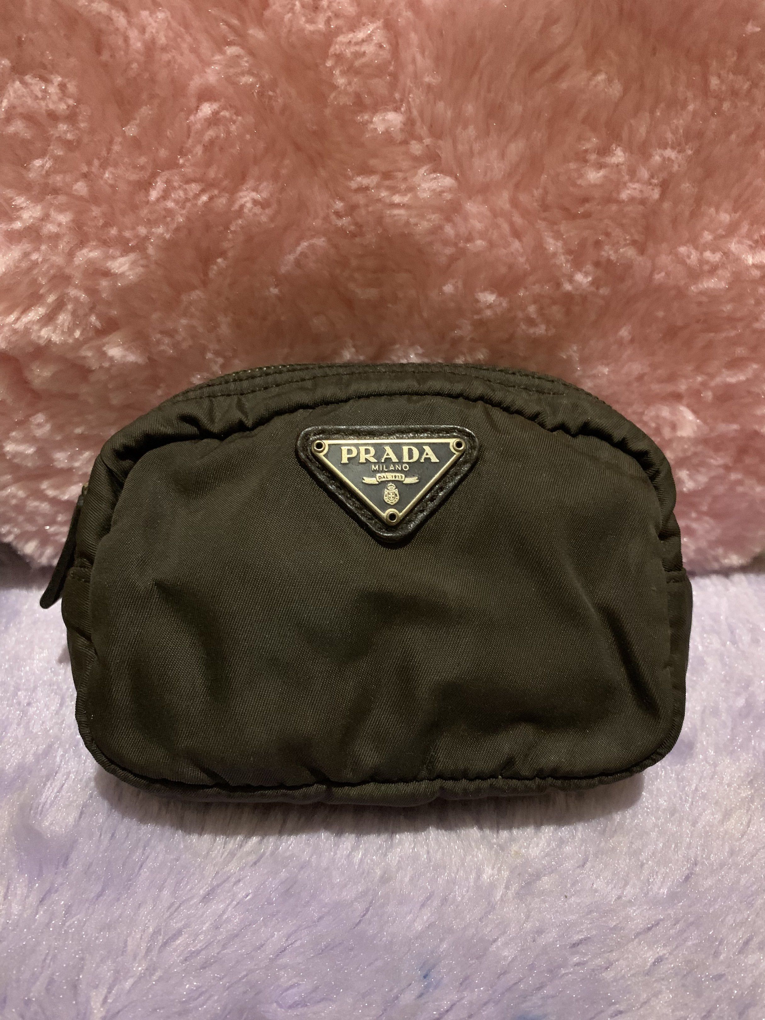 Prada Black Cosmetic Pouch (Category: Luxury Bags & Wallets) located in Quezon City. Submitted by ncjnc (Listing ID 1418926258, Image 1). Description: - Authentic Prada cosmetic pouch in black - Features iconic triangular Prada logo - Interior includes leather tag with Prada logo - Zipper is marked with "LAMPO" - Includes tag with the number "58".