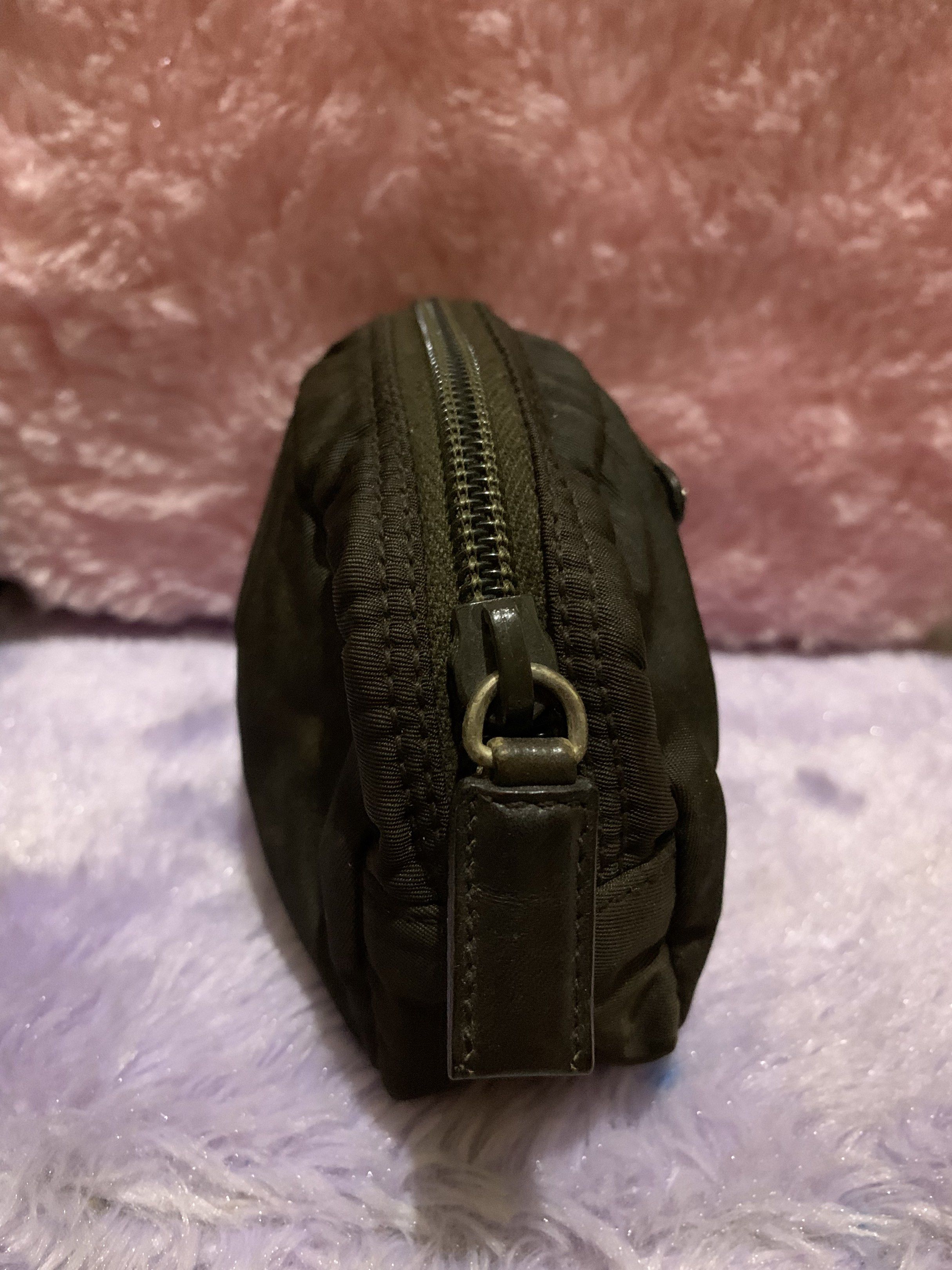 Prada Black Cosmetic Pouch (Category: Luxury Bags & Wallets) located in Quezon City. Submitted by ncjnc (Listing ID 1418926258, Image 2). Description: - Authentic Prada cosmetic pouch in black - Features iconic triangular Prada logo - Interior includes leather tag with Prada logo - Zipper is marked with "LAMPO" - Includes tag with the number "58".