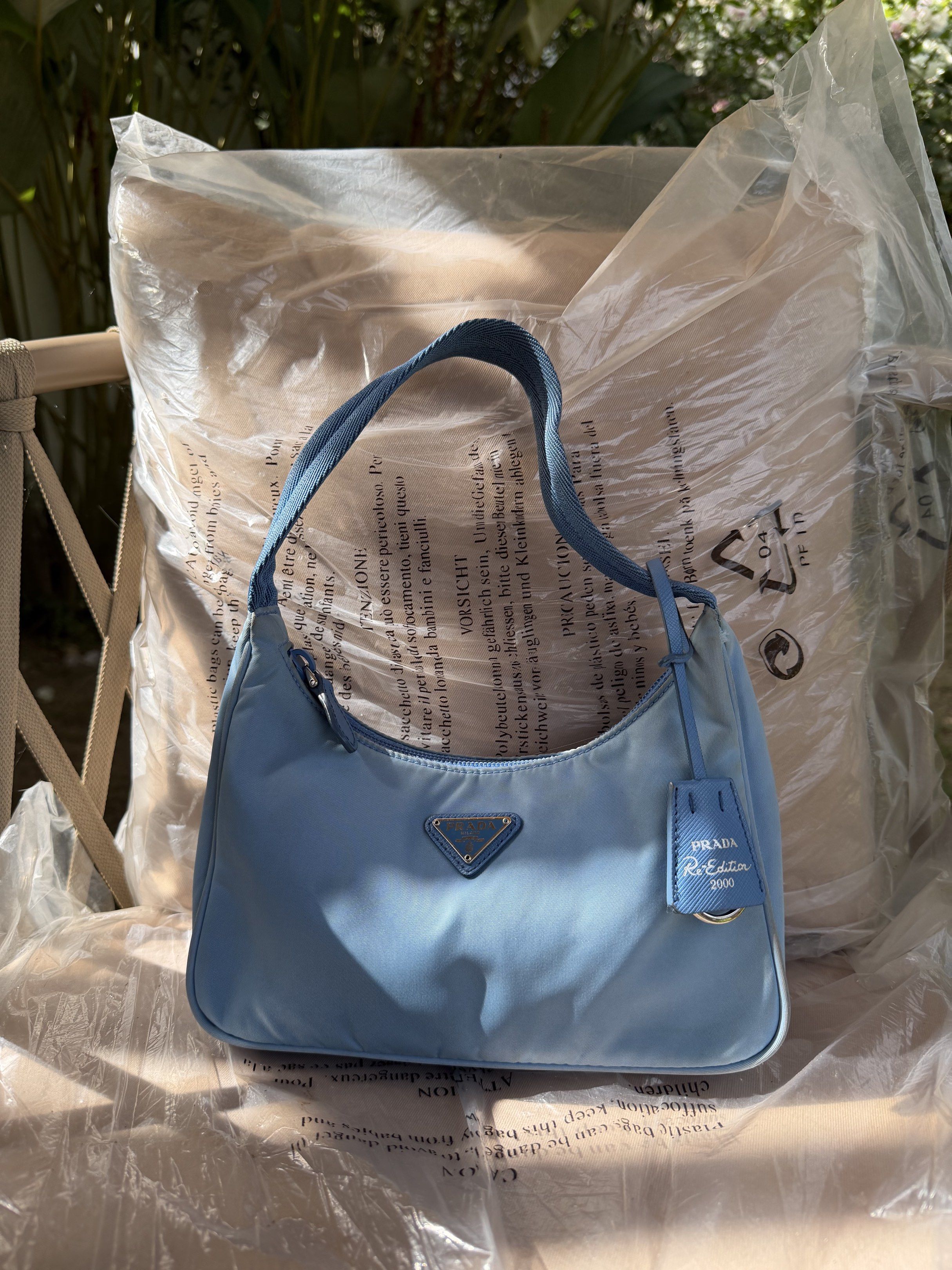 Prada Re-Edition 2000 Mini Bag - Baby Blue (Category: Luxury Bags & Wallets) located in Plaridel. Submitted by marquezdiane (Listing ID 1418842586, Image 1). Description: - Authentic Prada Re-Edition 2000 mini bag - Baby blue nylon exterior - Minimal signs of usage dirt matatanggal sa bagspa - Matching blue handle - Detachable leather tag - Prada Milano interior label - Zipper closure - Made in Italy - Includes original prada dustbag.