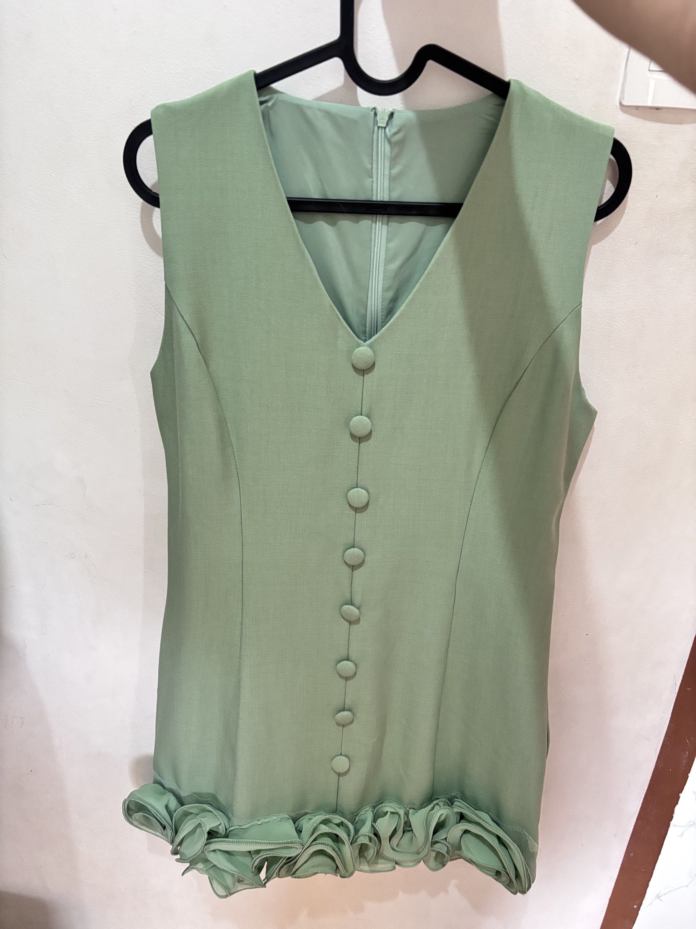 Sage Green Sleeveless Top with Ruffle Hem (Category: Sleeveless) located in Meycauayan. Submitted by declutter0403 (Listing ID 1418818061, Image 1). Description: - Sleeveless top - V-neckline - Button-down front - Ruffle hem detail - Back zipper closure - Soft sage green color - Made of smooth, woven fabric.