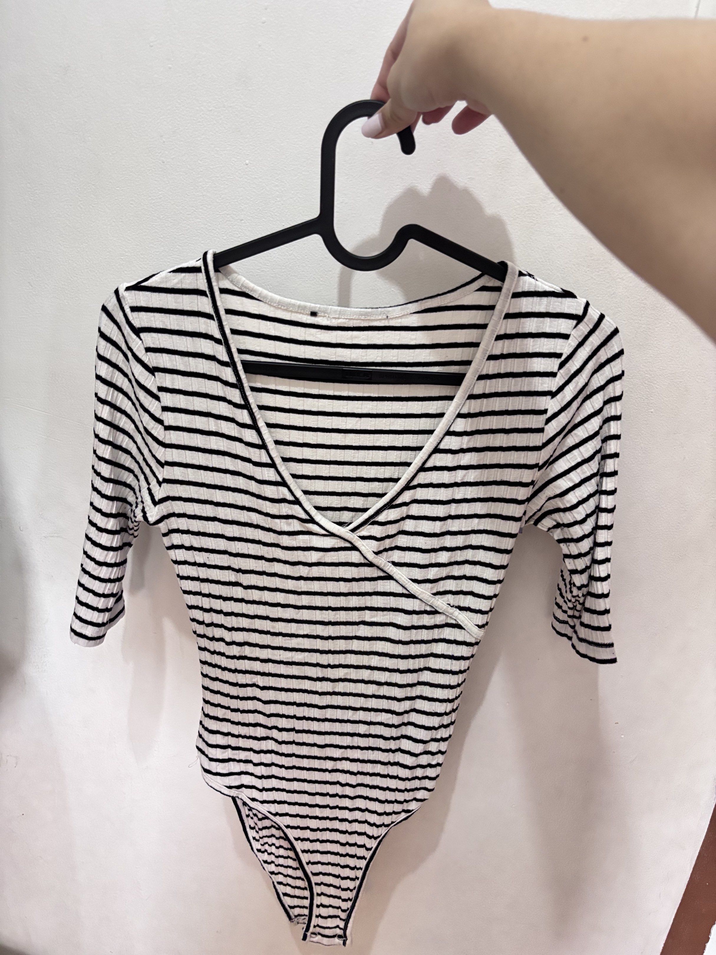 Striped Wrap Bodysuit (Category: Others Tops) located in Meycauayan. Submitted by declutter0403 (Listing ID 1418844701, Image 1). Description: - Black and white striped bodysuit - Wrap design - Short sleeves - V-neckline - Ribbed fabric.