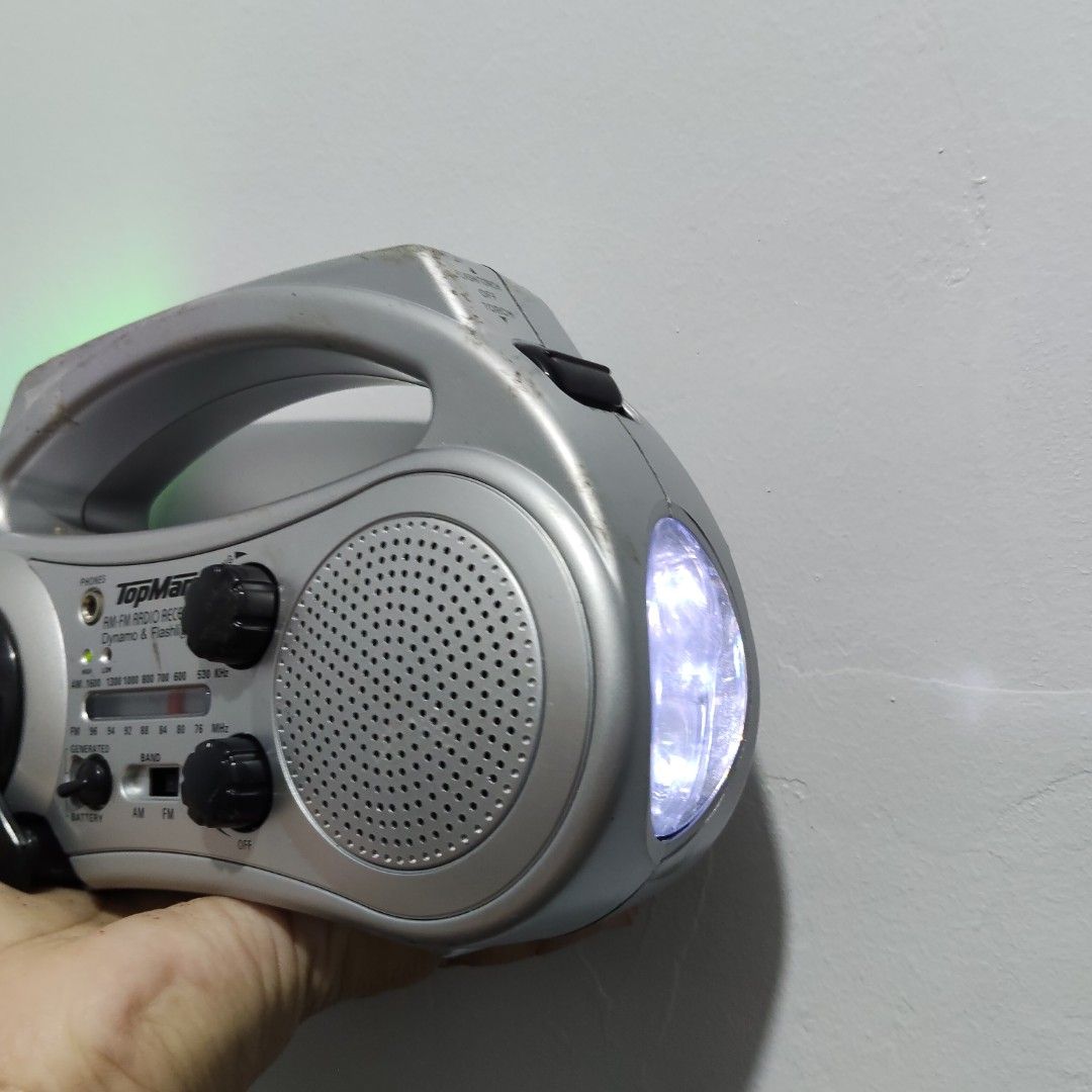 TopMan AM/FM Dynamo Radio w/ Flashlight (Category: Portable Music Players) located in Catbalogan. Submitted by jpnsrpls (Listing ID 1418976206, Image 2). Description: 📻 TopMan AM/FM Dynamo Radio w/ Flashlight ✅ ALL FUNCTIONS WORKING & TESTED 🔊 AM / FM radio 🔦 Built-in flashlight 🔄 Hand-crank (dynamo) power 🔌 With charging jack (no rechargeable battery included) 🔋 Battery-operated 🎧 With earphone jack 🧳 Portable with carry handle.