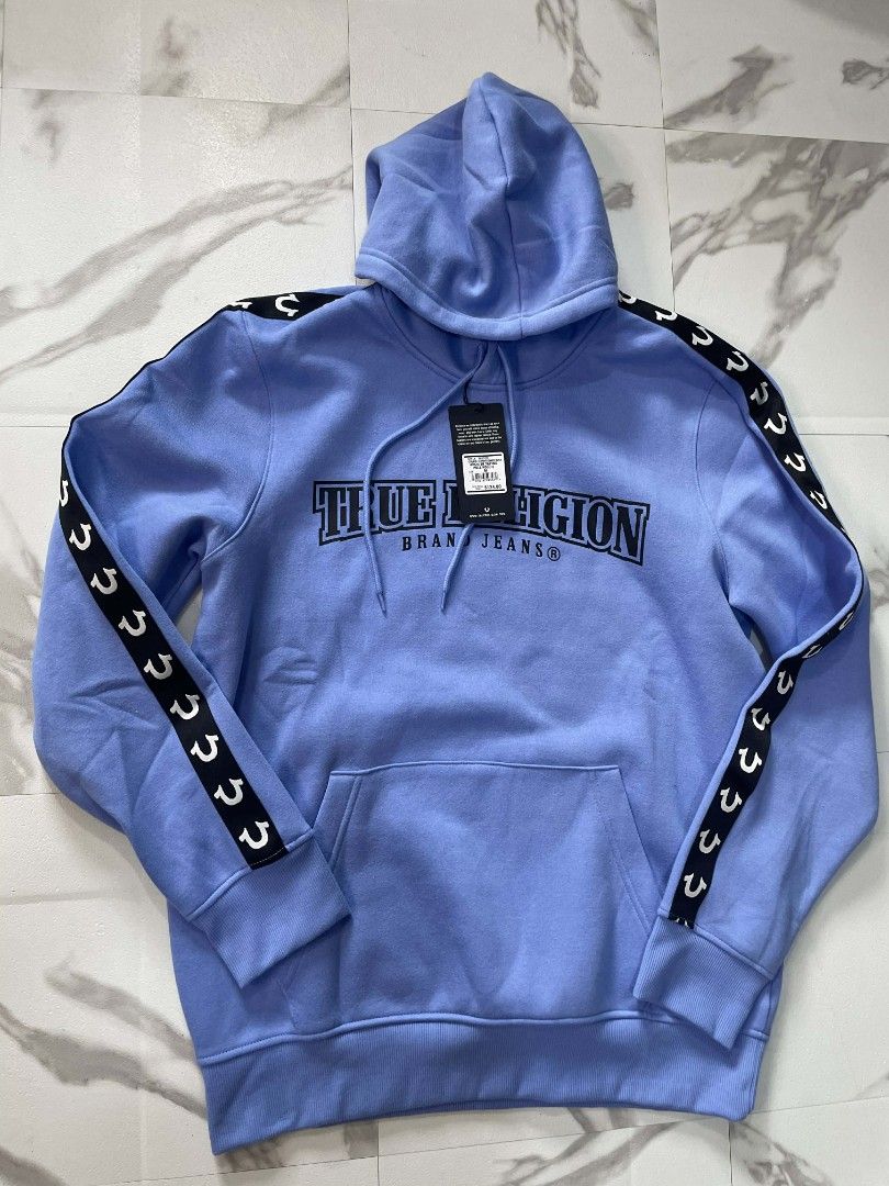 True Religion Arch TR Taping Pull Hoodie - Cornflower Blue (Category: Hoodies) located in Cabuyao City. Submitted by litzky2971 (Listing ID 1418818903, Image 1). Description: - Authentic True Religion hoodie - Color: Cornflower Blue - Size: M - Features: - Brand logo on chest - Horseshoe taping on sleeves - Hood with drawstrings - Kangaroo pocket - Style: Arch TR Taping Pull Hoodie - Retail Price: "$124".