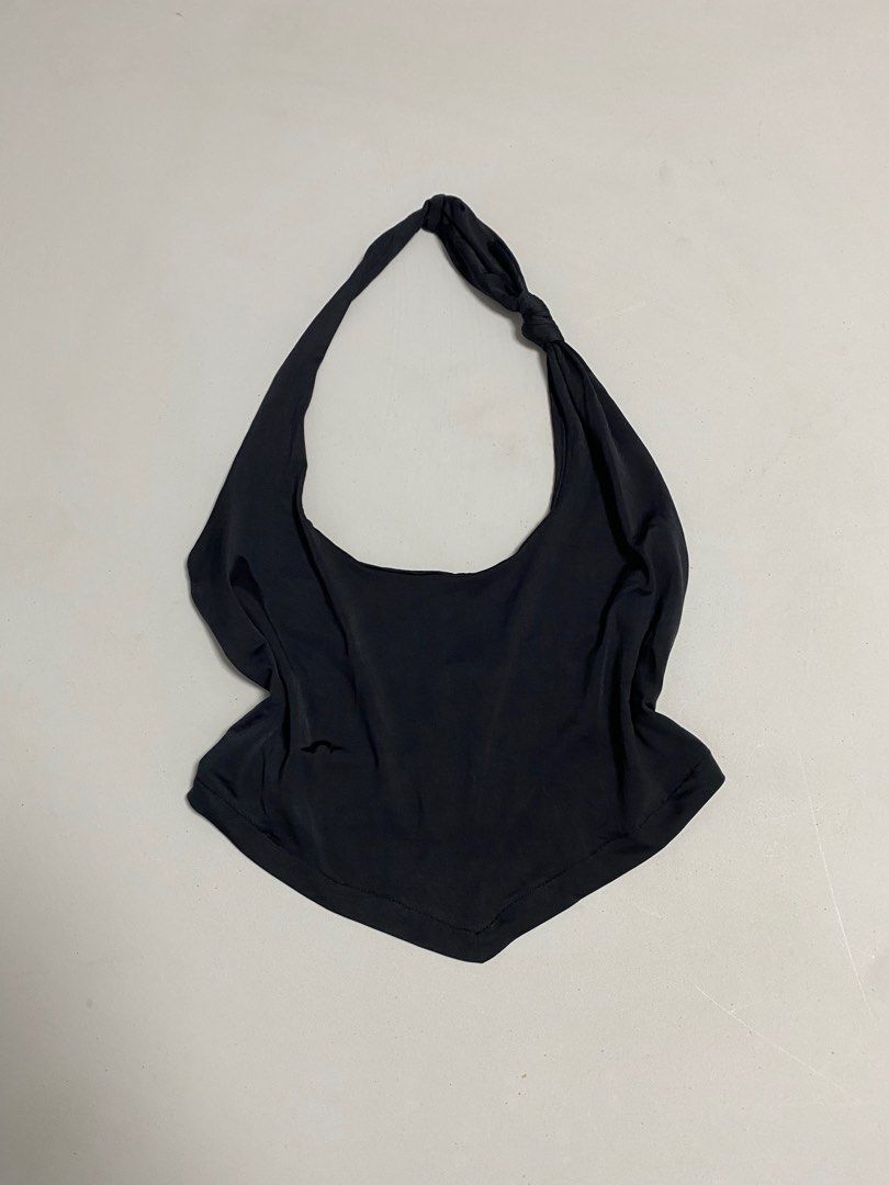 Urban Outfitters Halter Top (Category: Sleeveless) located in Calamba. Submitted by curse.thin_ (Listing ID 1418779670, Image 1). Description: - Urban Outfitters black halter top - Size: Small - Unique knotted strap design - Made of soft, draping fabric - Versatile for various occasions.