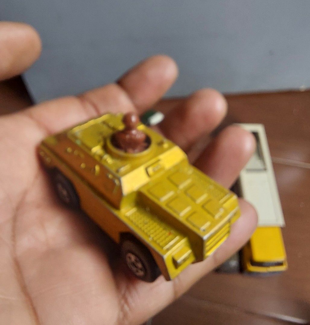 Vintage Matchbox Skybusters Armored Car (Category: Vehicle & Diecast Models) located in Pasig City. Submitted by liezel-liezel (Listing ID 1418826728, Image 2). Description: - Vintage Matchbox Skybusters armored car toy - Features a yellow body - Includes a brown figure in the turret - Underside marked with "Matchbox" and "Lesney Products", Made in England - Black wheels - Detailed design.