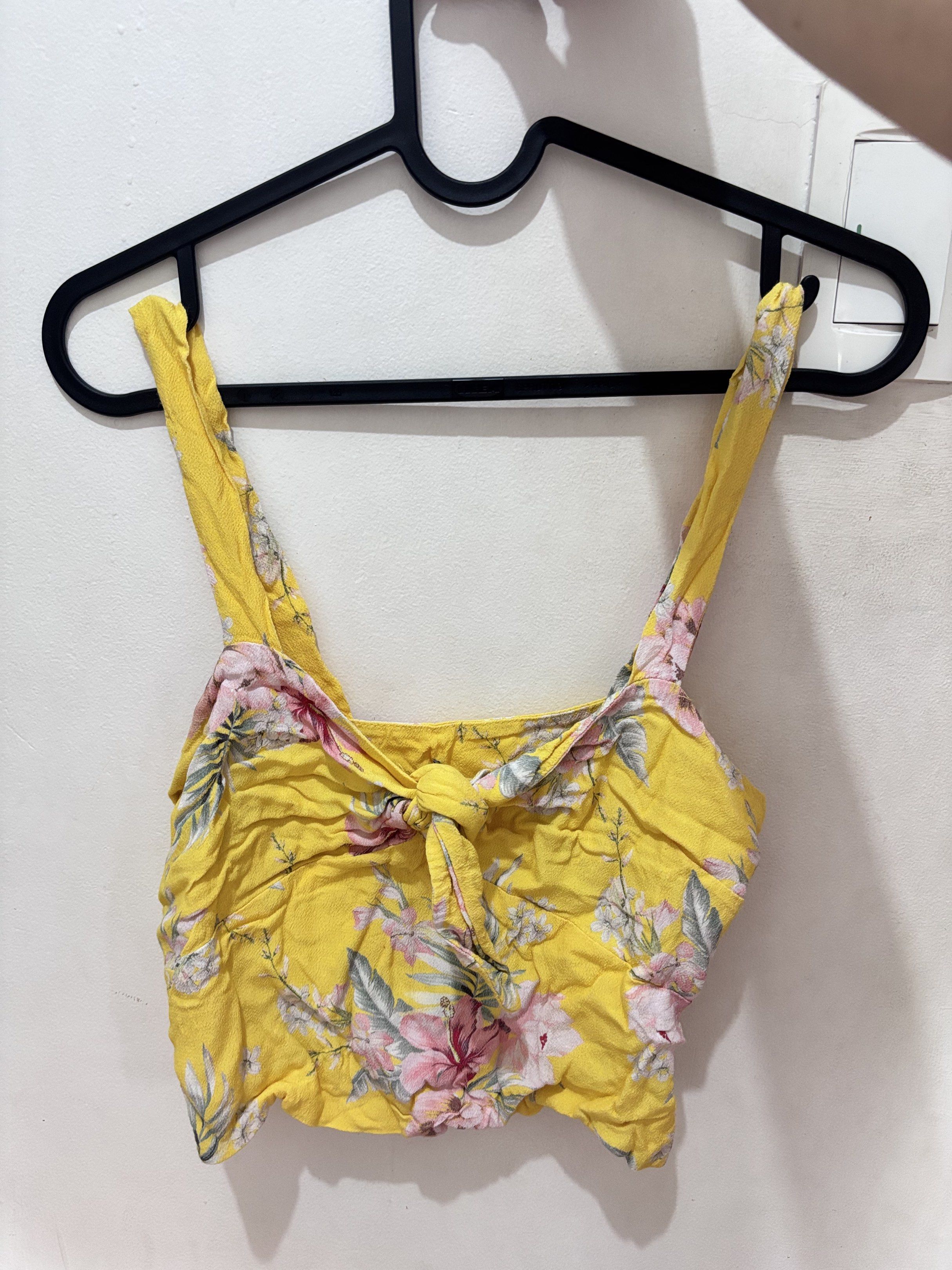 Yellow Floral Crop Top (Category: Others Tops) located in Meycauayan. Submitted by declutter0403 (Listing ID 1418845767, Image 1). Description: - Yellow crop top - Floral print design - Wide straps - Tie detail at front - Made of lightweight fabric - Ideal for warm weather - Pairs well with high-waisted bottoms.