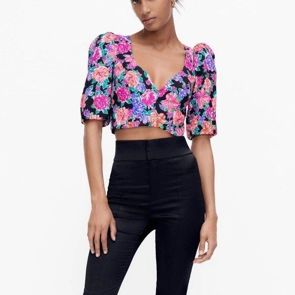 Zara Floral Crop Top (Category: Blouses) located in Santa Rosa. Submitted by paupaocollection (Listing ID 1418781217, Image 2). Description: - Zara crop top with vibrant floral print - Flattering V-neckline - Short, puffed sleeves - Cropped length - Black base with colorful floral patterns - Lightweight fabric - Bnew with tag Small.