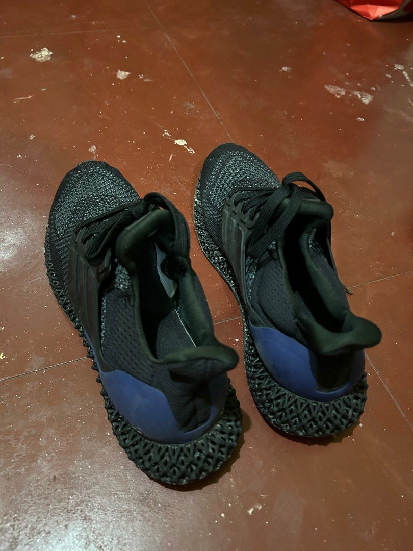 Adidas Ultraboost 4D Black size 10 (Category: Sneakers) located in Pasay City. Submitted by lils_shoppe (Listing ID 1413449558, Image 2). Description: - Adidas Ultraboost 4D sneakers - Color: Black - Features 4D midsole - Black laces - Signs of wear on soles and uppers - Blue accent on heel counter - Adidas logo visible .