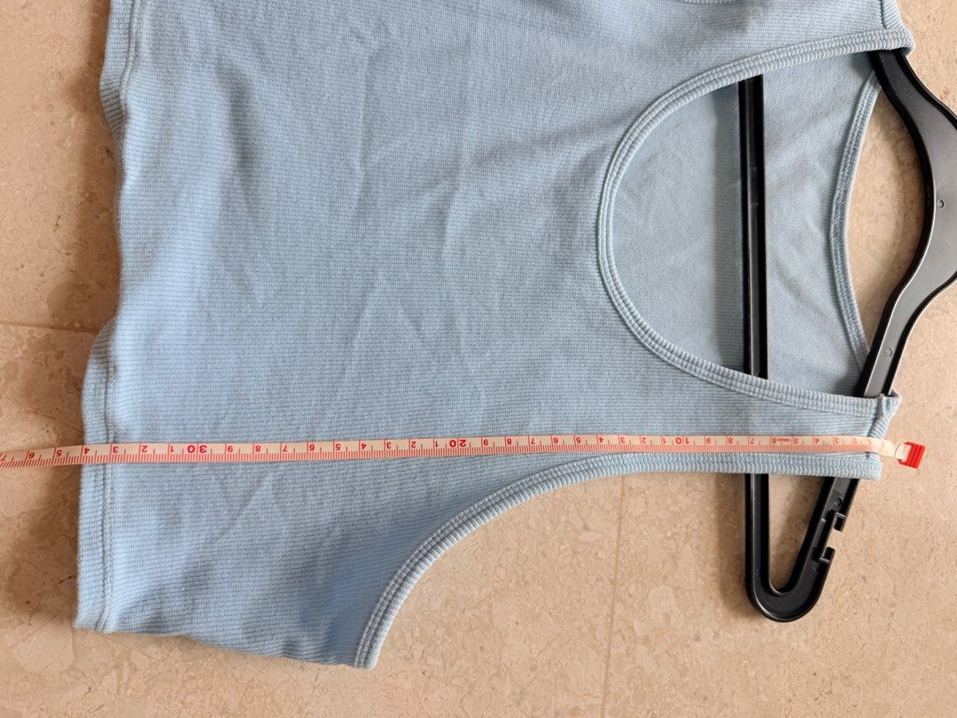 Alo Yoga Ribbed Tank Top - Baby Blue (Category: Activewear) located in Singapore. Submitted by chanelyjy (Listing ID 1413555582, Image 3). Description: - Alo Yoga tank top - Light blue ribbed fabric - Cropped length - Scoop neckline - Measurements in photos - Perfect for workouts and casual wear • Brand: Authentic Alo Yoga • Color: Soft light blue (pastel/ice blue) • Style: Ribbed crop tank, scoop neck, racerback design, fitted and stretchy • Mat