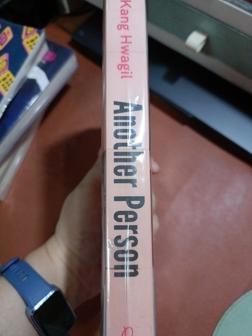 Another Person by Kang Hwagil (Category: Storybooks) located in Manila. Submitted by rosyclouds94 (Listing ID 1413470345, Image 3). Description: Authentic Paperback Copy of "Another Person" by Kang Hwagil, bought from Fully Booked. Read only once. - Fiction novel translated from Korean. - Explores the mystery of Jina and events at Anjin University. - Published by Pushkin Press. - Features a pink and white cover design with critic quotes..