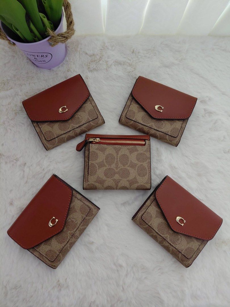 Authentic Coach Signature Card Wallet (Trifold) (Category: Luxury Bags & Wallets) located in San Fernando. Submitted by simplypurseandfragrances (Listing ID 1413479072, Image 1). Description: - Authentic Coach wallet - Signature Coach pattern - Brown leather flap - Compact design - Multiple card slots - Small zippered compartment - Coach logo detail - Stylish and functional.