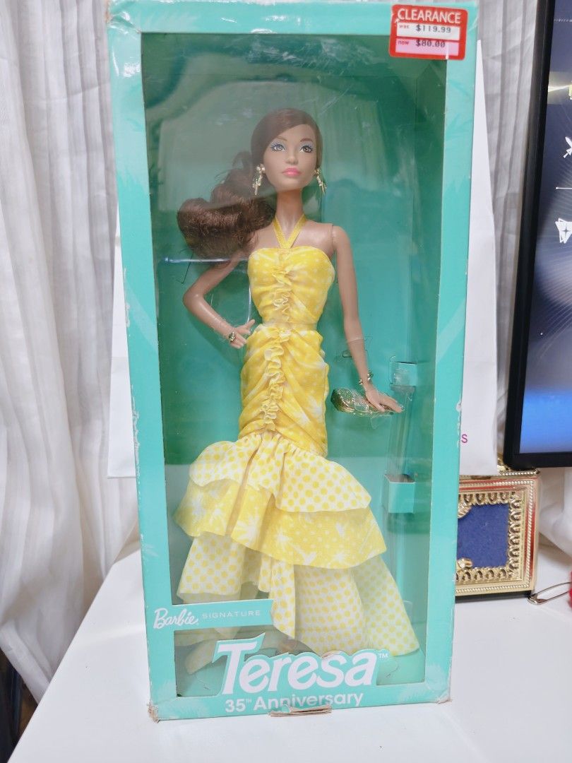 Barbie Teresa 35th Anniversary Doll (Category: Figurines & Statues) located in Pasig City. Submitted by lian_sam (Listing ID 1413600043, Image 3). Description: - Barbie Teresa 35th Anniversary Edition - Features a doll with brown hair and a yellow dress - Still in original packaging - NRFB bot not mint.