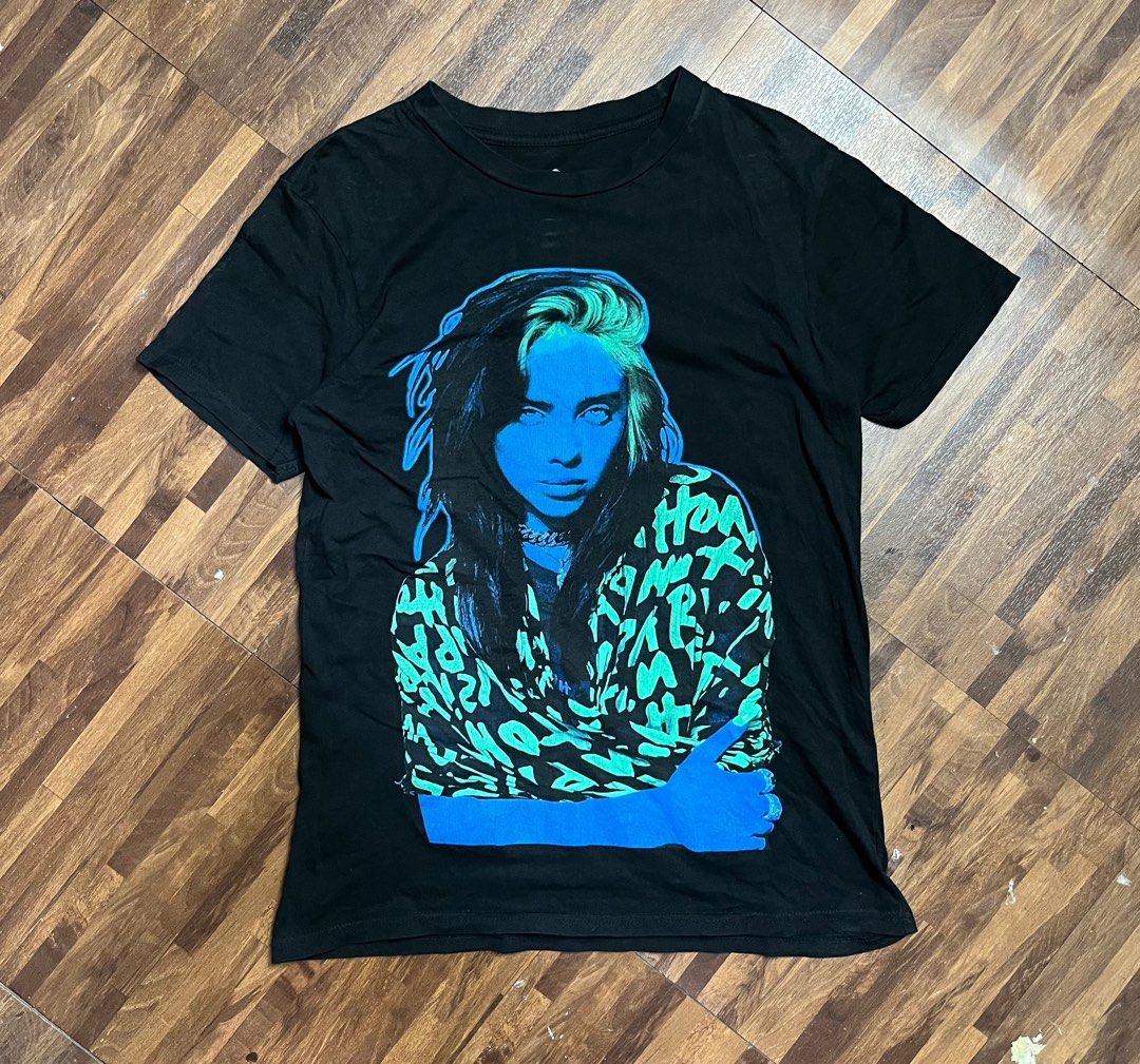 Billie Eilish 2021 Merch Tee (Category: Tshirts & Polo Shirts ) located in Cabanatuan. Submitted by refind-ph (Listing ID 1413540551, Image 1). Description: Billie Eilish 2021 Merch Tee Dimes 17.5 x 26 inches Very good condition No issue Color rate 9/10 Dm to purchase! 📩.