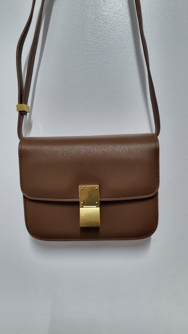 Brown Crossbody Bag with Gold Hardware (Category: Luxury Bags & Wallets) located in Paranaque City. Submitted by jaymiedg (Listing ID 1413607859, Image 2). Description: - Brown crossbody bag - Rectangular shape with flap closure - Gold-colored hardware - Adjustable long strap - Multiple interior compartments - Includes a zippered compartment - Made of smooth material - Perfect for everyday use Payment method: GCash or Bank transfer *Price still n