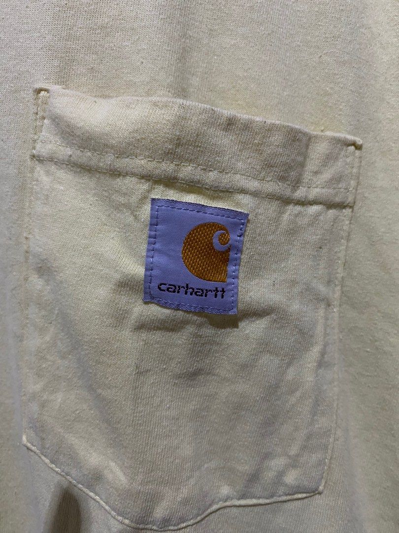 Carhartt Loose Fit Pocket Tee (Category: Tshirts & Polo Shirts ) located in Panabo. Submitted by skanaker (Listing ID 1413623525, Image 2). Description: - Carhartt pocket tee - Light yellow color - Size: Medium - Loose fit - Features chest pocket with Carhartt logo - Made in Honduras - Includes washing instructions on tag .