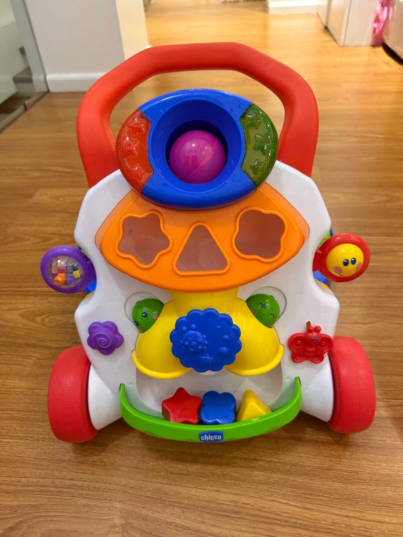 Chicco Walki Talky Baby Walker (Category: Infant Playtime) located in Quezon City. Submitted by ishaaaaang (Listing ID 1413589098, Image 1). Description: Condition 9/10 Bought at ₱5,990 - Chicco baby walker - Colorful design - Interactive elements - Handle for easy pushing - Playful front panel with shapes, buttons, and rolling ball - Wheels for mobility - Smiley face design - Designed to help babies learn to walk.