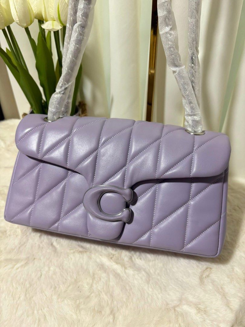 Coach Pillow Tabby Shoulder Bag 26 (Category: Luxury Bags & Wallets) located in San Fernando. Submitted by simplypurseandfragrances (Listing ID 1413477858, Image 2). Description: - Coach Pillow Tabby 26 Shoulder Bag - Stylish lavender color - Quilted design - Signature C clasp - Chain strap - Spacious interior with zip pocket - Includes Coach hang tag.