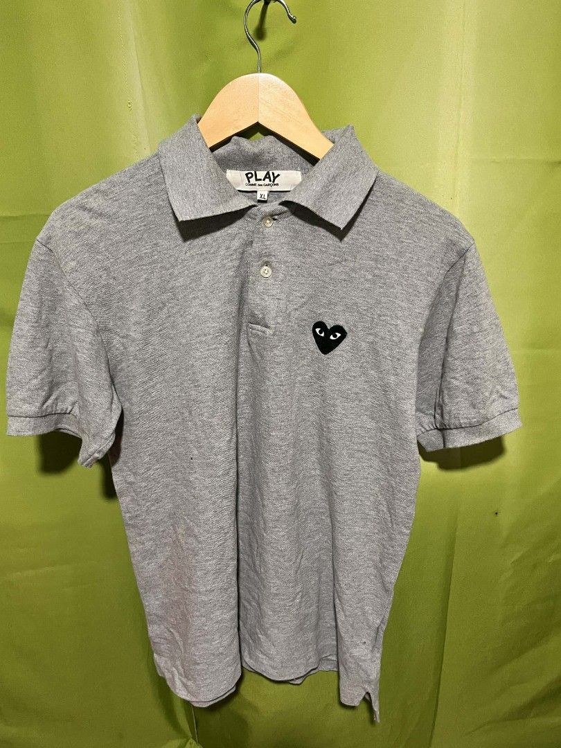 Comme des Garcons Play Polo Shirt (Category: Tshirts & Polo Shirts ) located in Balagtas. Submitted by rethroarchives (Listing ID 1413591501, Image 1). Description: - Comme des Garcons Play polo shirt - Features the iconic black heart logo - Classic polo collar - Short sleeves - Made of comfortable, breathable fabric - Perfect for casual wear.