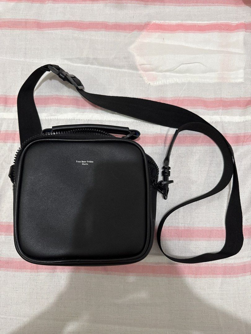 Free Smart Friday Crossbody Bag (Category: Sling Bags) located in Pasig City. Submitted by clouddansahh14 (Listing ID 1413580632, Image 1). Description: - Free Smart Friday crossbody bag - Square shape - Top handle and adjustable shoulder strap - Zippered main compartment - Brand name visible on front - Made of smooth, leather-like material .
