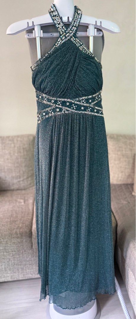 Green Embellished Halter neck Formal Gown (Category: Evening dresses & gowns) located in Las Pinas. Submitted by bitsnfinds (Listing ID 1413468337, Image 2). Description: Worn once. Dark green embellished halter neck, bare back formal long gown. Elegantly criss-cross beaded with silver and clear gems highlighting your body curves. Flowing gown of soft shimmery material. Perfect fit for small to medium size, length from shoulder to bottom is 55 in