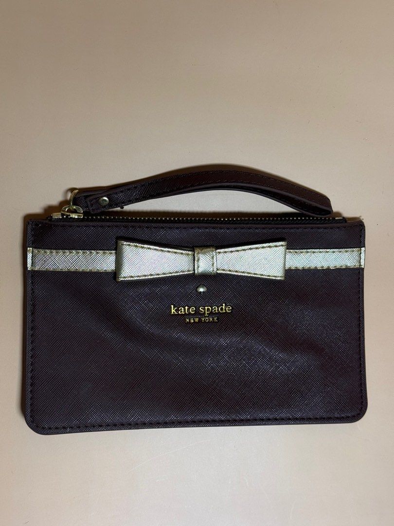 Kate Spade Bow Wristlet (Category: Wallets & Card holders) located in Pasig City. Submitted by chikaching (Listing ID 1413436766, Image 1). Description: - Kate Spade wristlet - Brown exterior - Silver bow detail - Zip closure - Wrist strap - Polka dot interior lining - Slightly Negotiable - Compact size - Perfect for essentials - Stylish accessory.