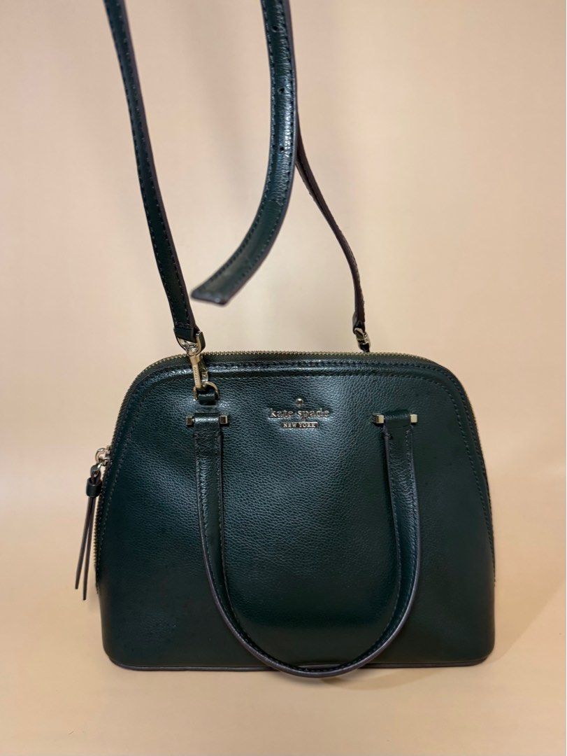 Kate Spade Green Leather Handbag (Category: Luxury Bags & Wallets) located in Pasig City. Submitted by chikaching (Listing ID 1413436534, Image 3). Description: - Kate Spade handbag - Dark green leather exterior - Top handle and detachable shoulder strap - Zip closure - Small zip pocket - Kate Spade logo on front - Slightly Negotiable.