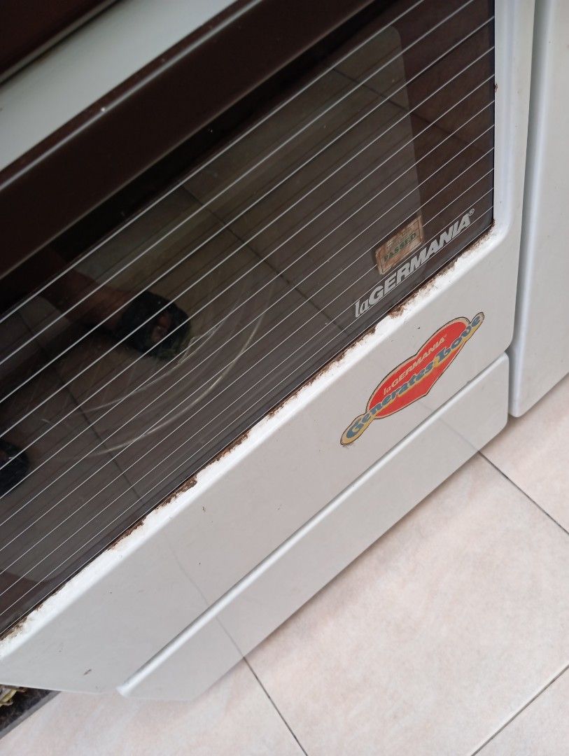 LaGermania Gas Range with Oven (Category: Ovens & Toasters) located in Muntinlupa City. Submitted by anythingboutiquebylala (Listing ID 1413497116, Image 2). Description: Germania gas range features a cooktop with four gas burners and one electric burner. It includes an oven with a glass door and a broiler. The control panel has knobs for burner and oven temperature adjustments. The range has a brown and white color scheme. It has an automatic ig
