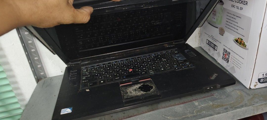 Lenovo ThinkPad Laptop (Category: Laptops & Notebooks) located in Quezon City. Submitted by jryance13 (Listing ID 1413540005, Image 1). Description: - Lenovo ThinkPad laptop - Features a red trackpoint - Touchpad has a damaged area - Sleek black design - Screen is open - Placed on a metal surface - Comes with a box.