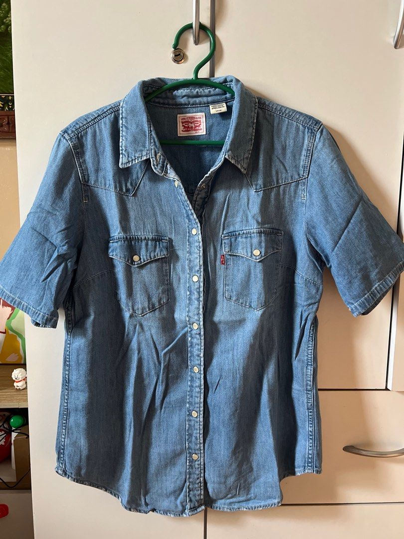 Levi's Denim Shirt (Category: Shirts) located in Bulacan. Submitted by monaami (Listing ID 1413444069, Image 1). Description: - Authentic Levi's denim shirt - Short sleeves - Size S/P/CH - Classic denim wash - Button-down front - Two chest pockets - Features Levi's red tab - Made in Bangladesh - Perfect for casual wear.