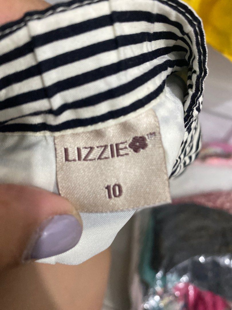 LIZZIE Striped Skirt Size 10 (Category: Skirts) located in Pasig City. Submitted by BonoBonoYeah (Listing ID 1413596673, Image 2). Description: - LIZZIE skirt - Size 10 - Black and white striped design - Yellow hem - Pleated style - Versatile for casual wear.